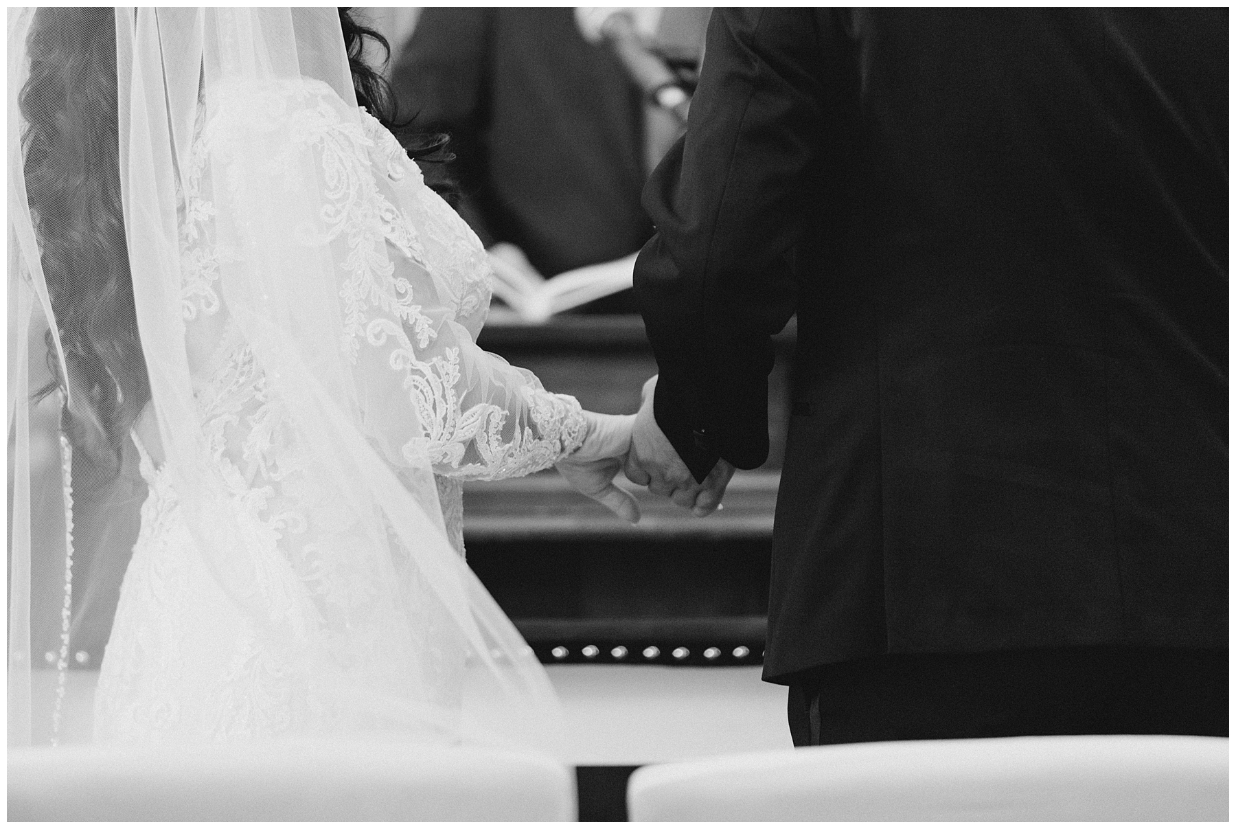 couple holding hands during wedding ceremony
