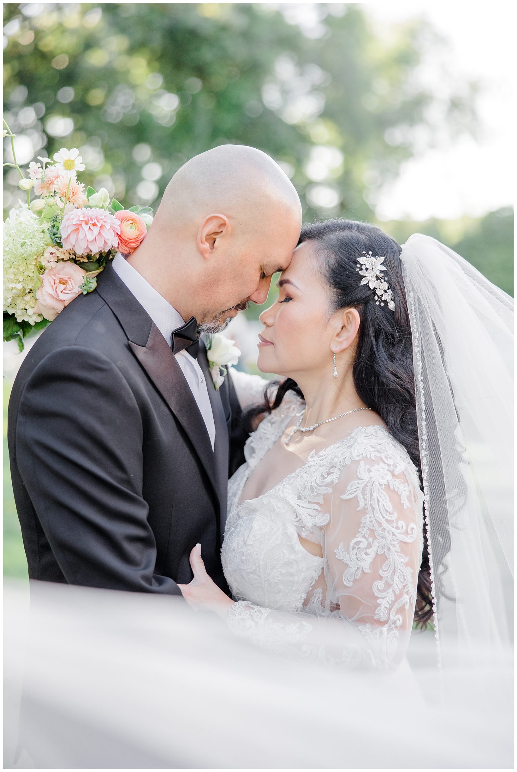 wedding portraits with veil wrapped around couple