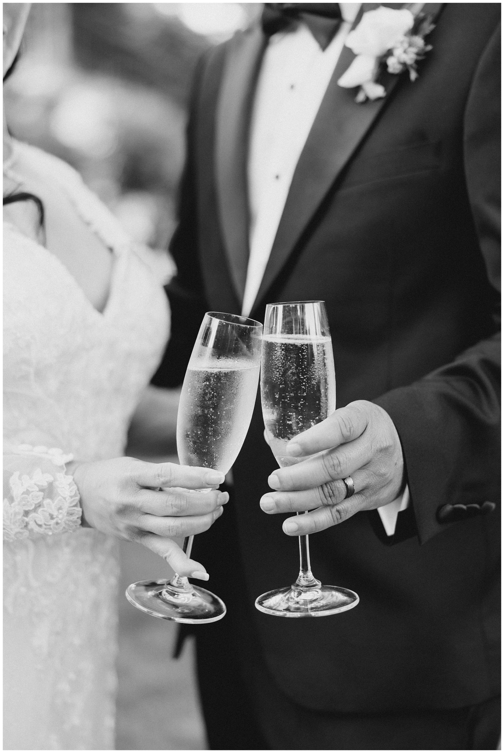 bride and groom toast a glass of champagne