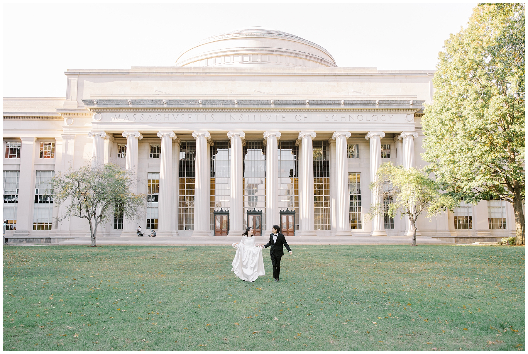 couple walking in the front lawn of MIT