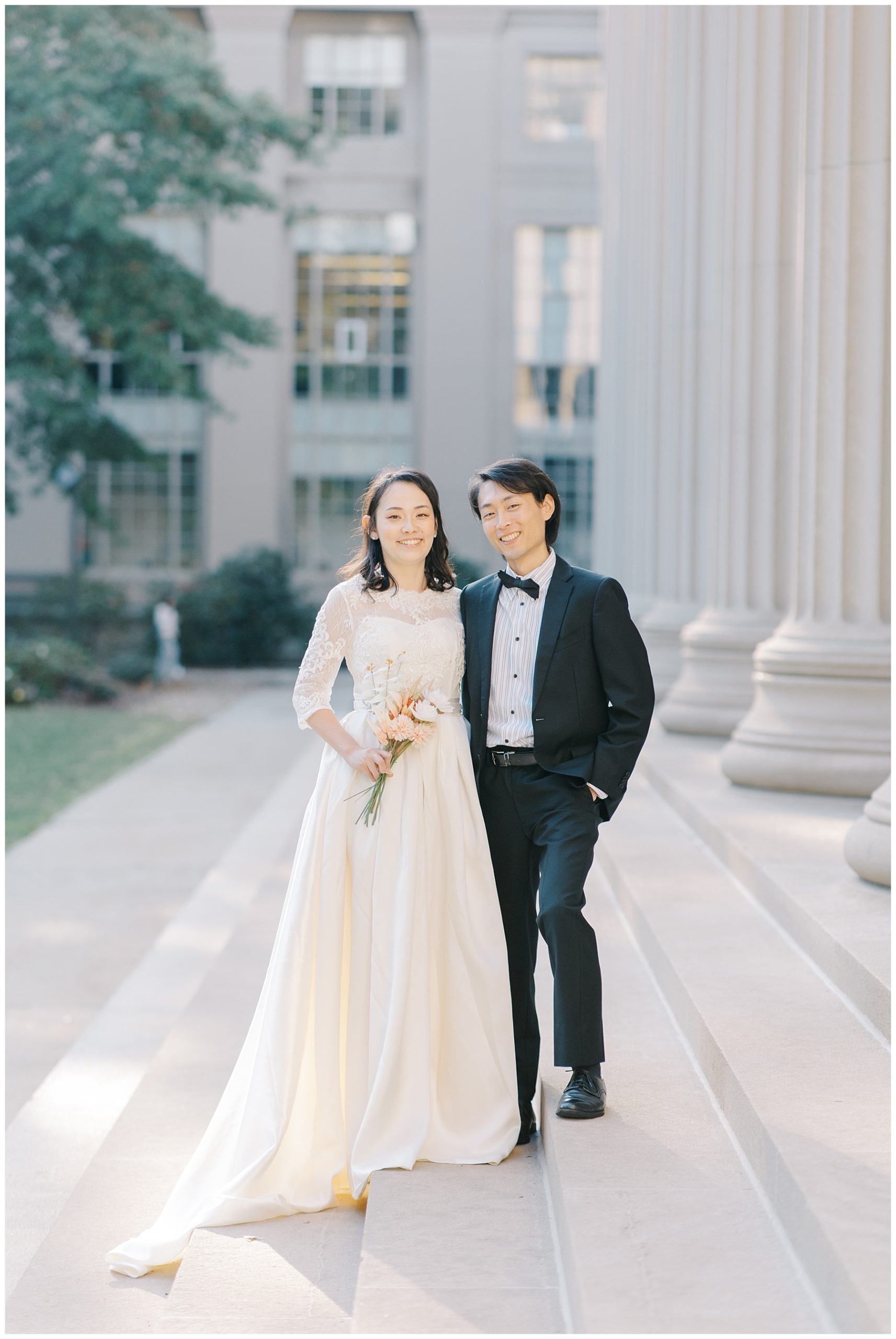 couple stands on stairs of MIT during wedding session