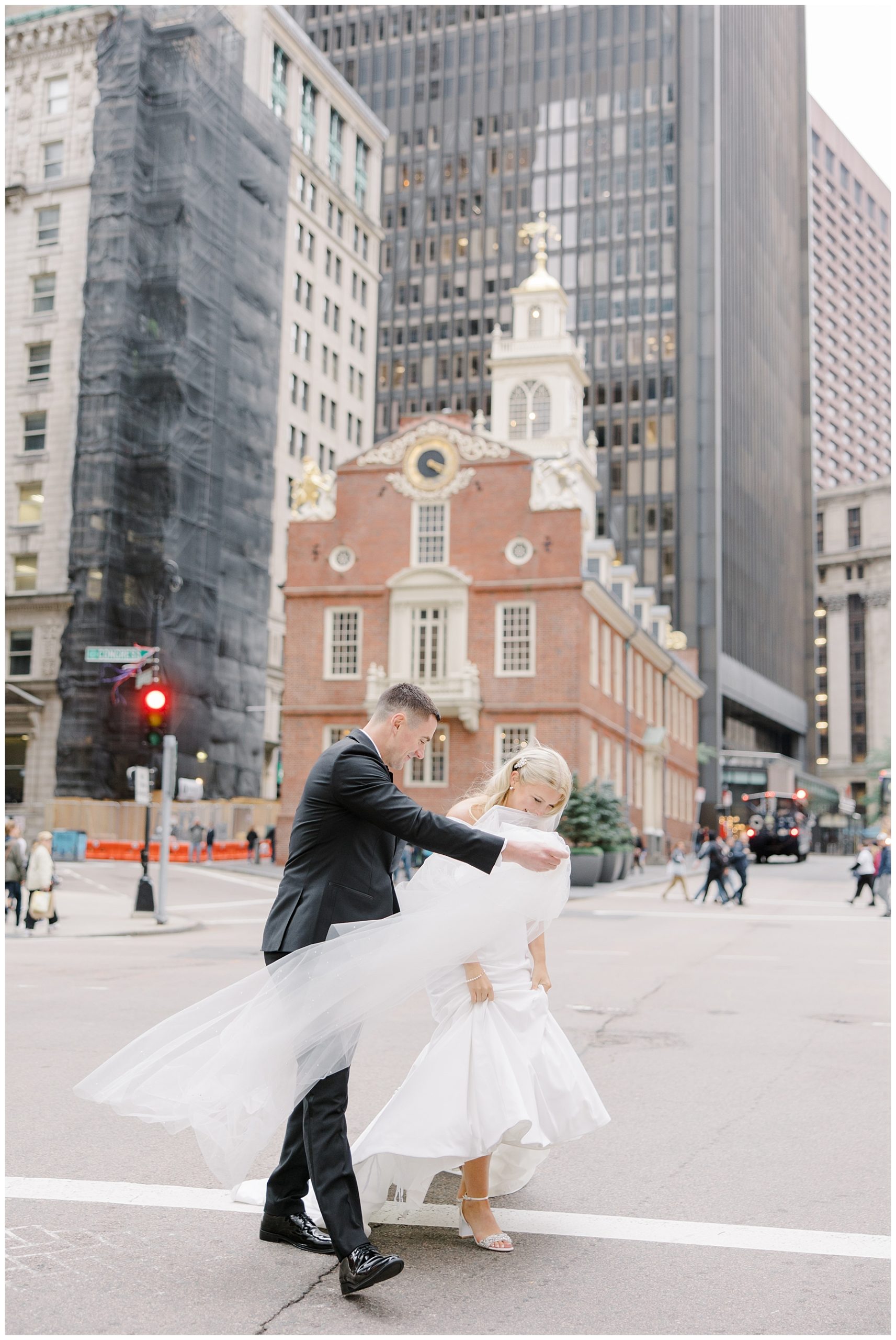 newlyweds walk across busy Boston street