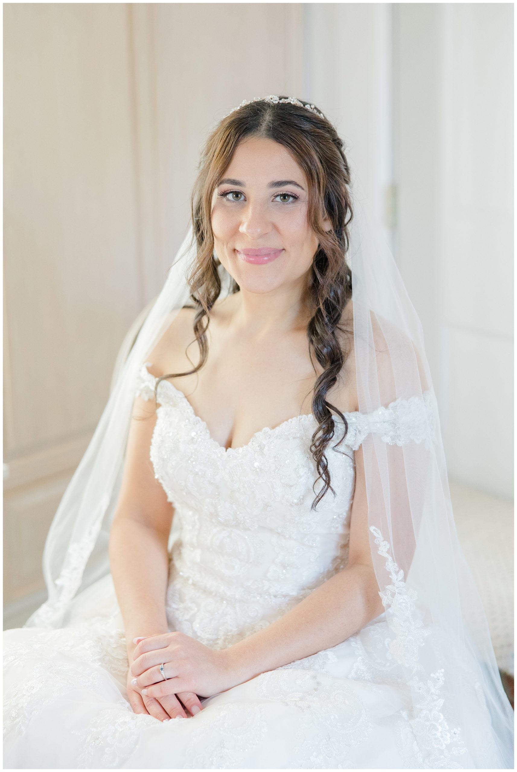 bride in off shoulder wedding dress and veil