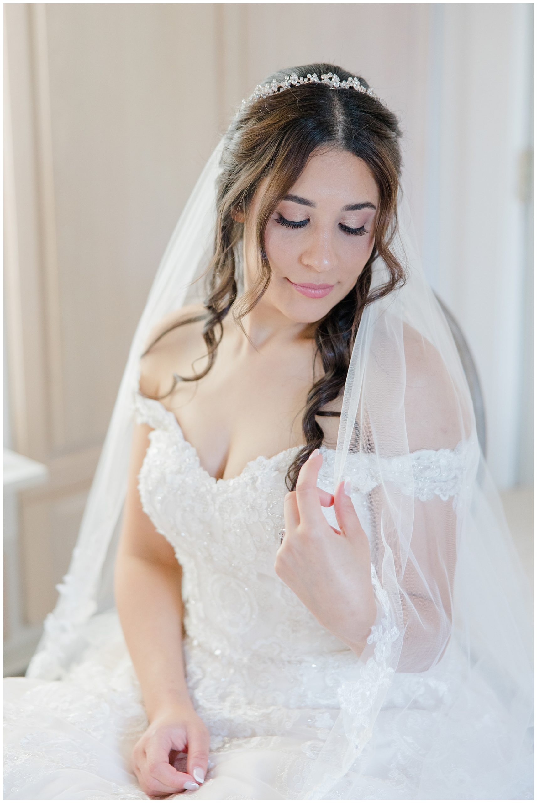 bride holding veil in her hands 