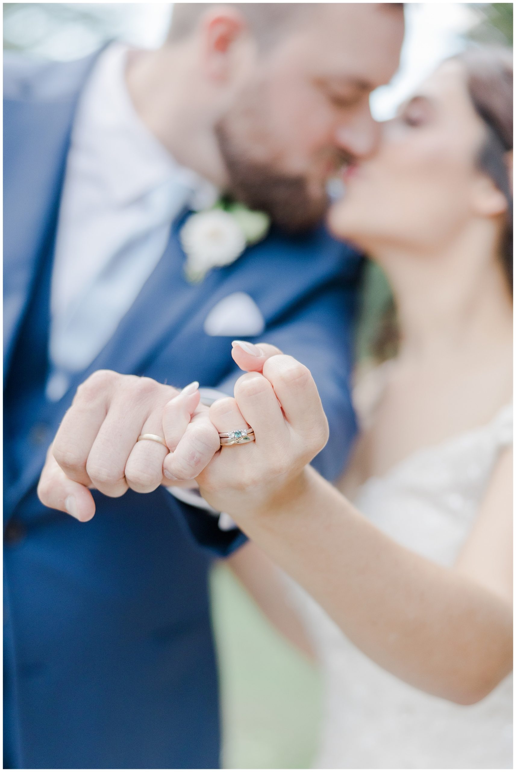 newlyweds kiss as they lock pinkies and show off wedding rings after Elegant New Hampshire Wedding ceremony