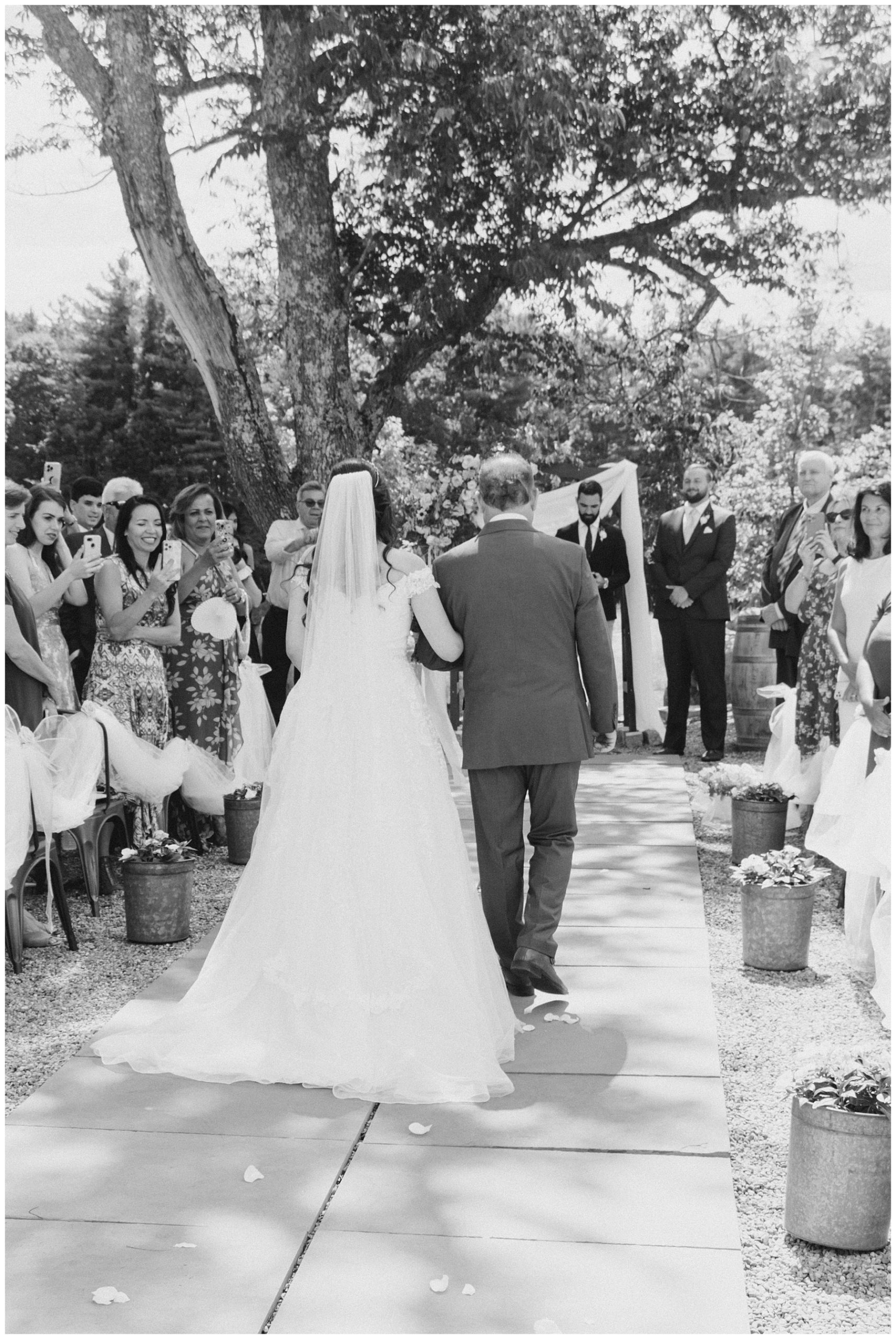 bride walks down aisle with her father 