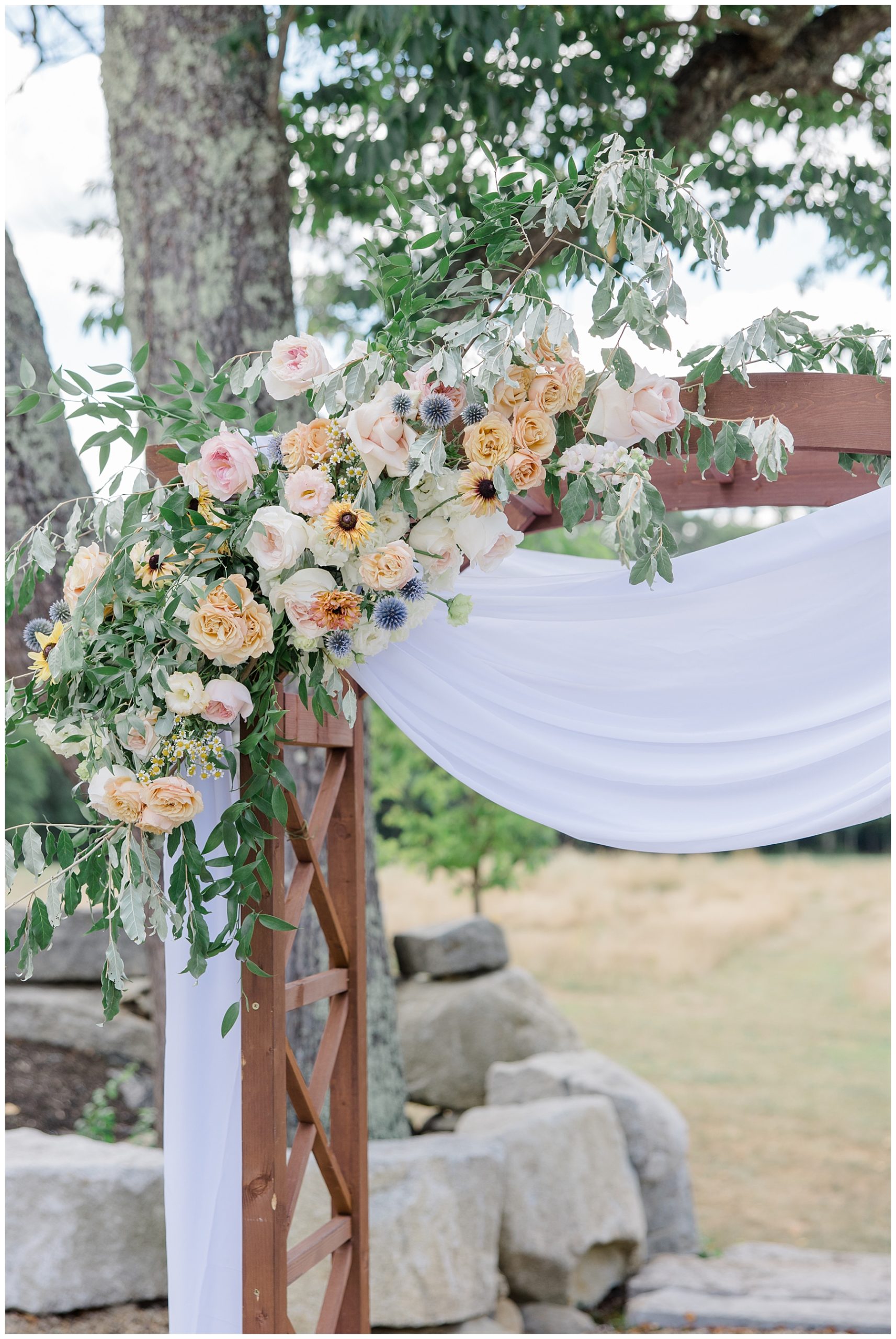 wedding flowers on wedding arch for outdoor ceremony 