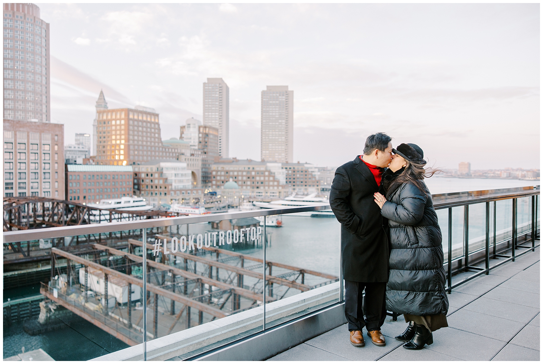couple kiss on Boston rooftop at Envoy Hotel