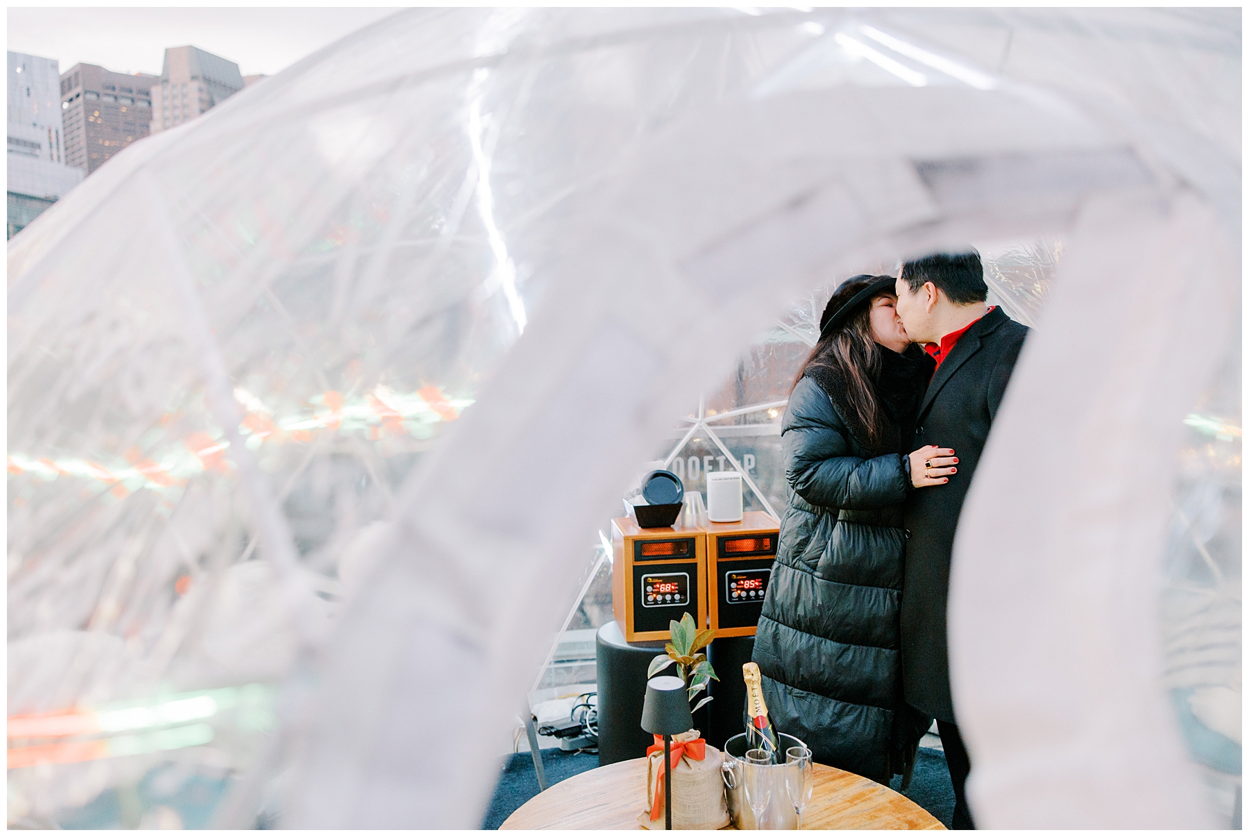 newly engaged couple kiss inside private igloo