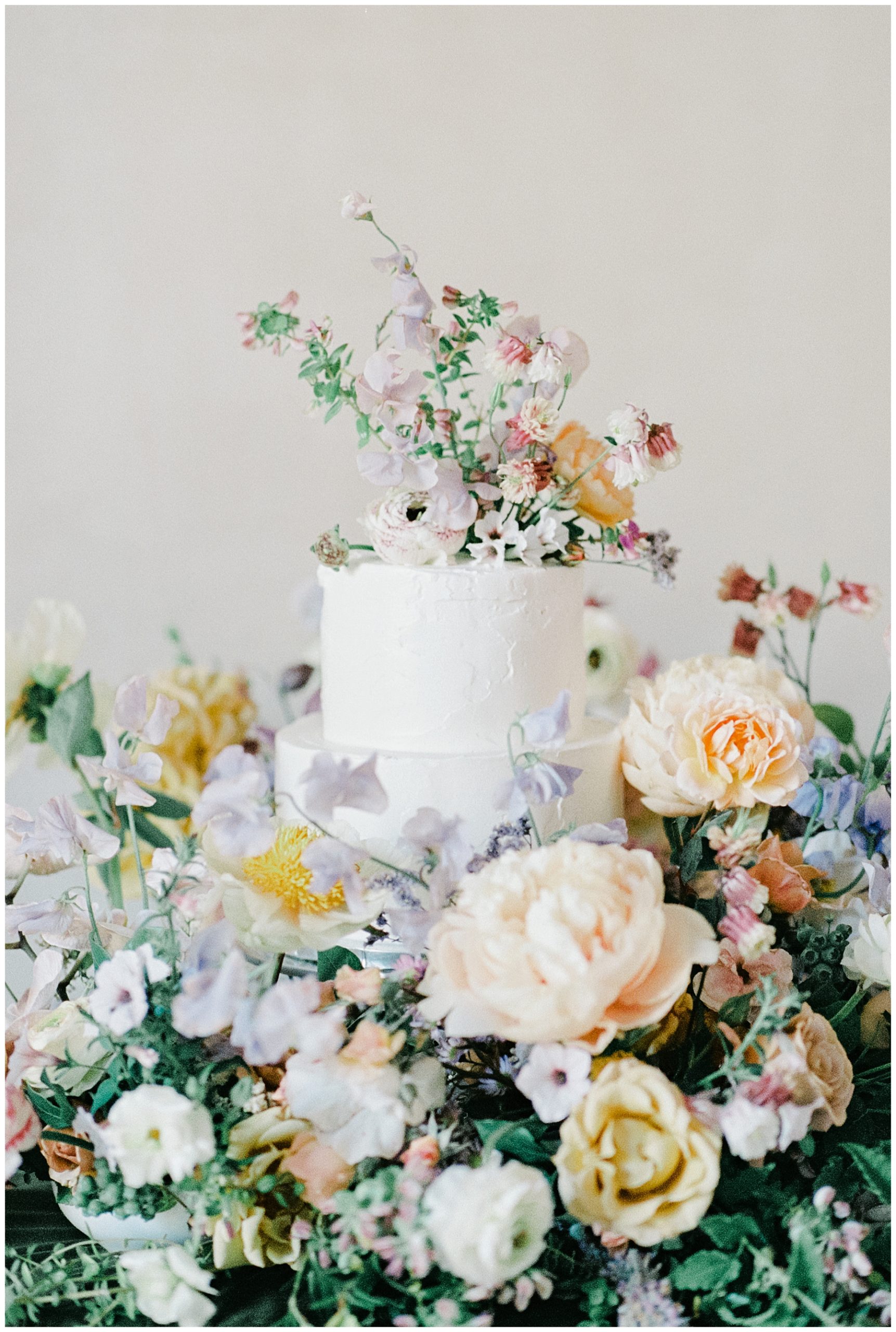 elegant arrangement of flowers around wedding cake