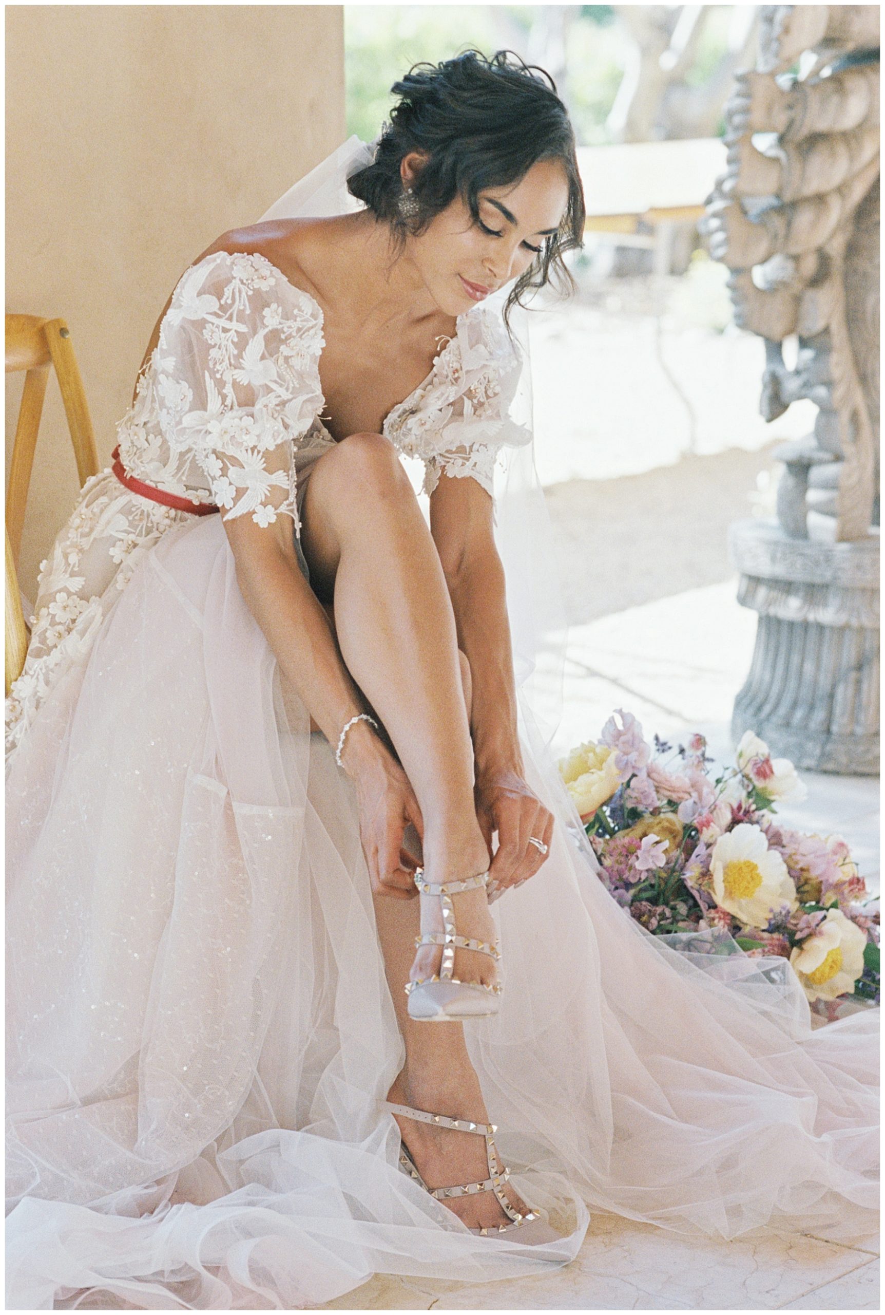 bride putting wedding shoes on