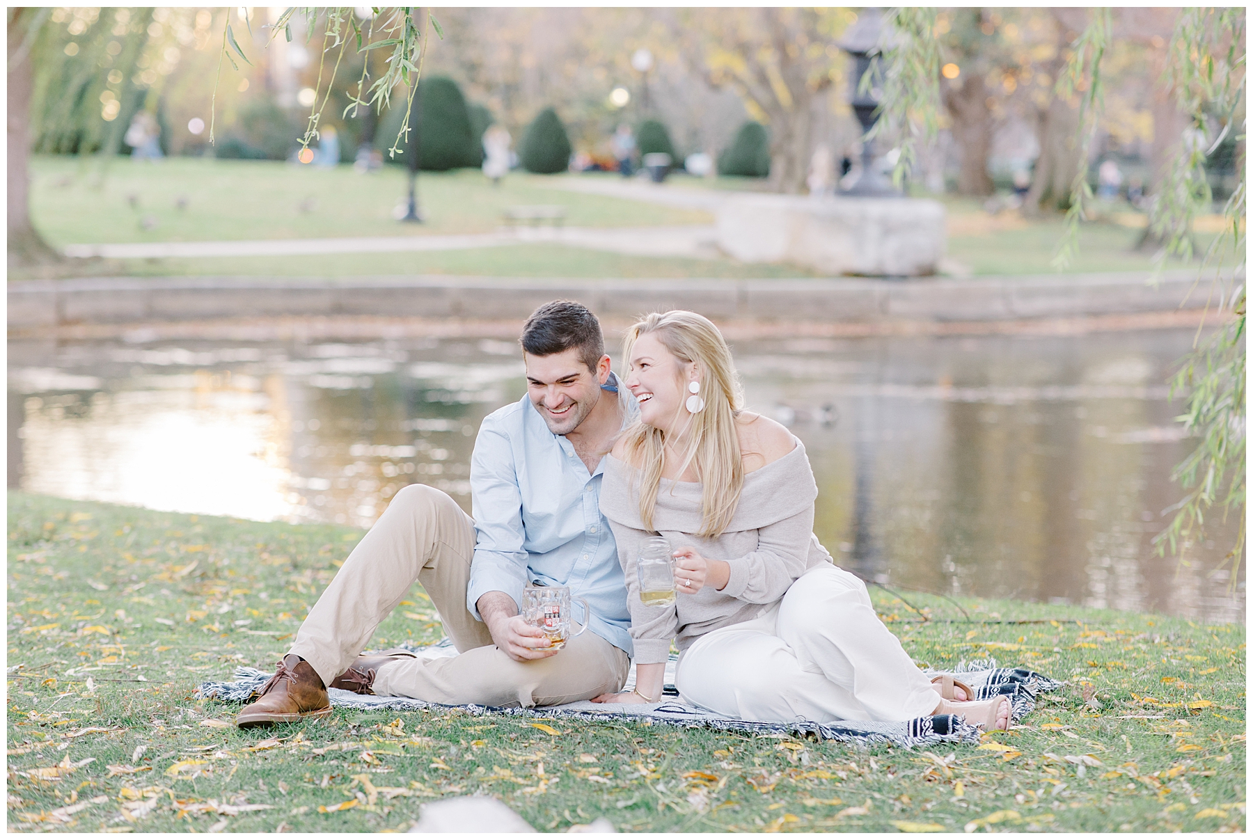 romantic portrait of couple sitting by pond during Intimate Boston Engagement