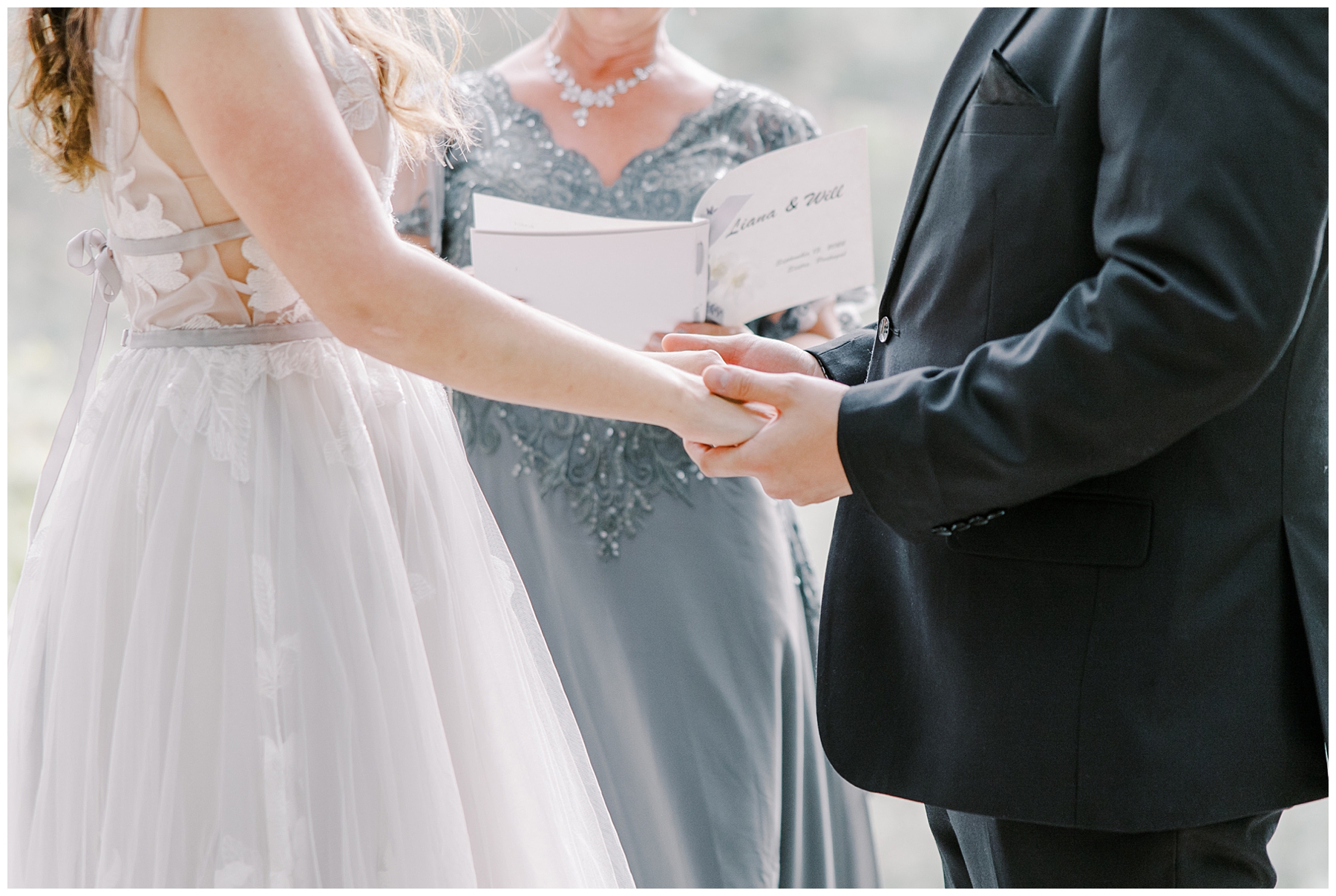 couple holding hands during intimate wedding ceremony
