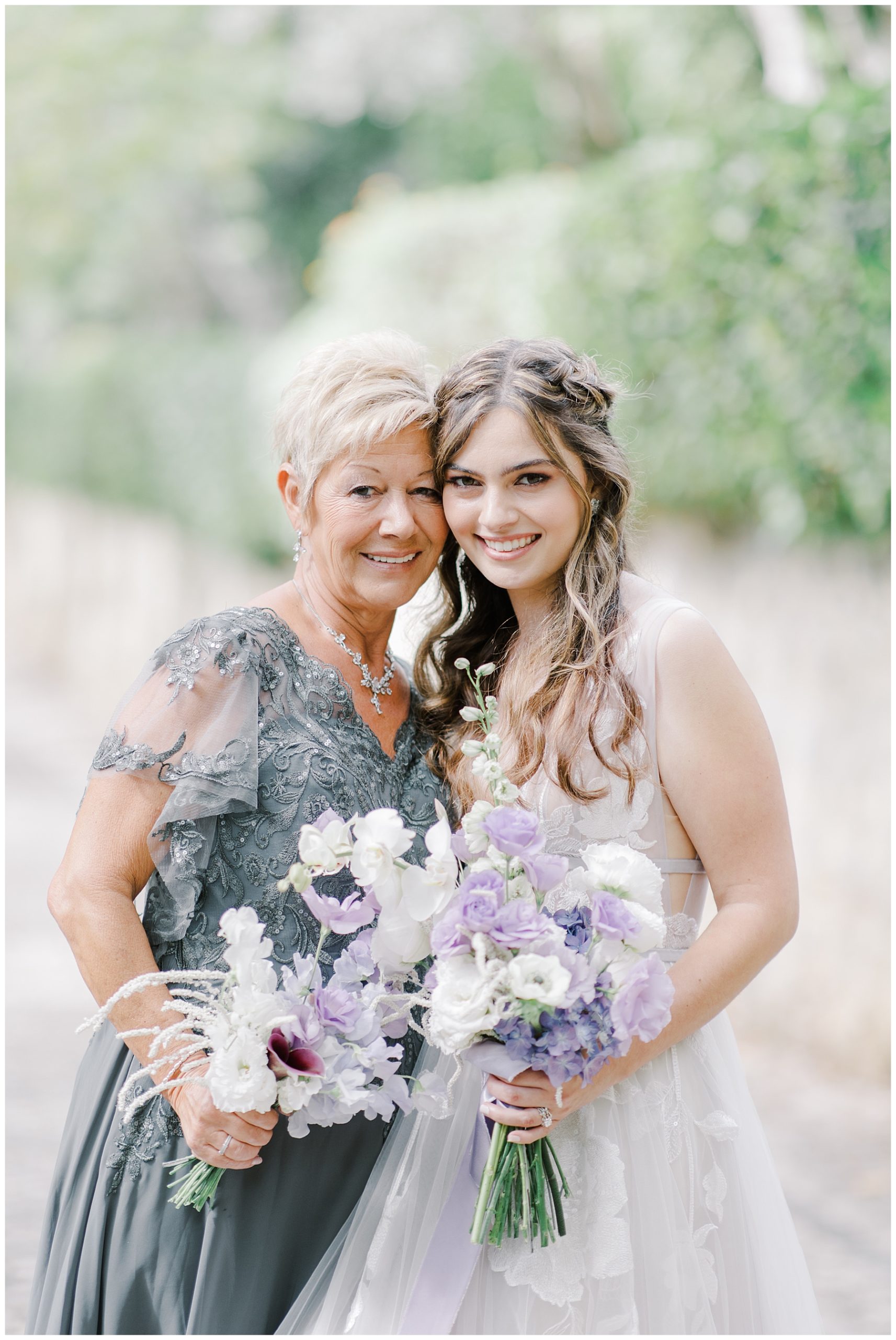 bride with her mom holding wedding bouquets 