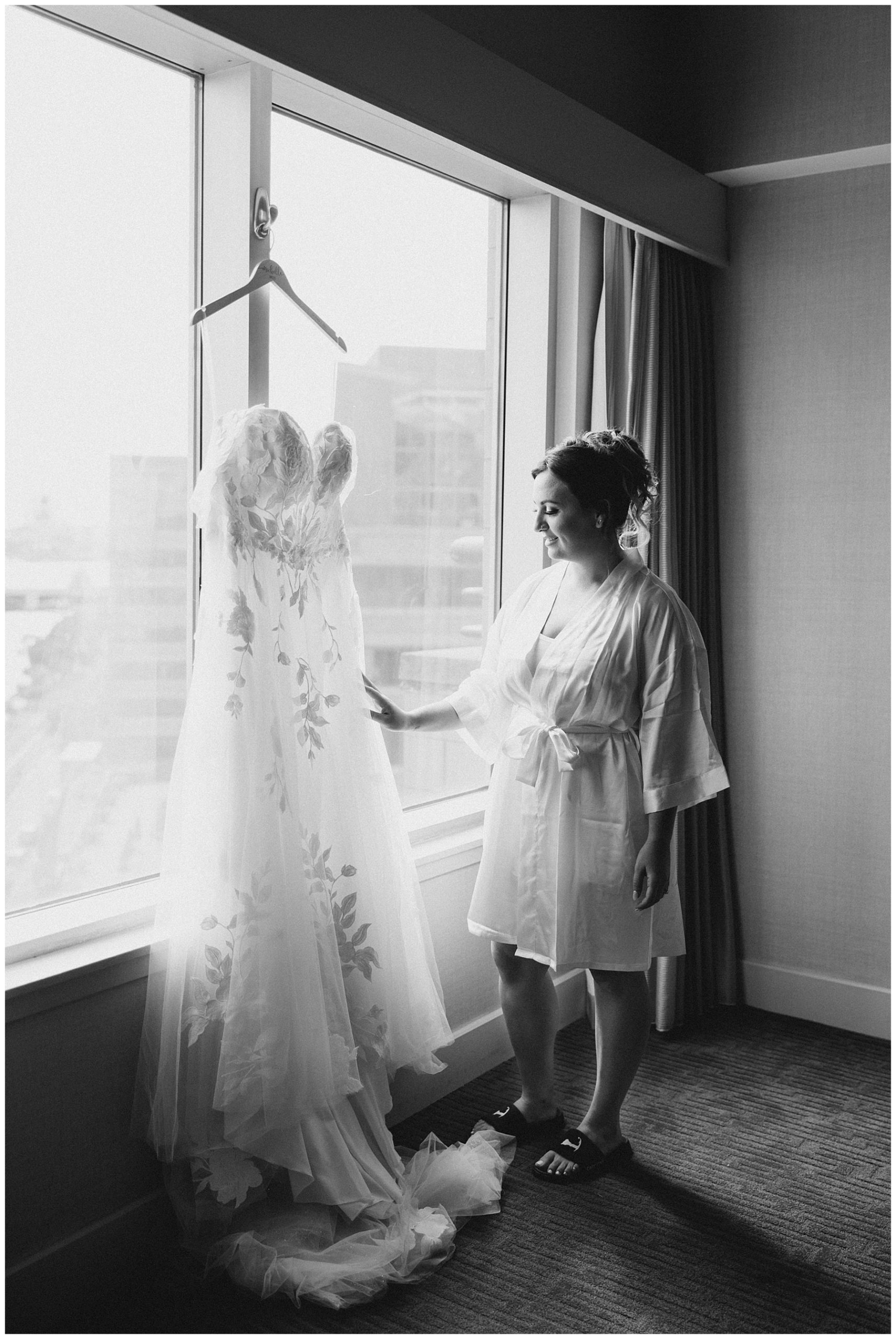 bride looking at wedding dress