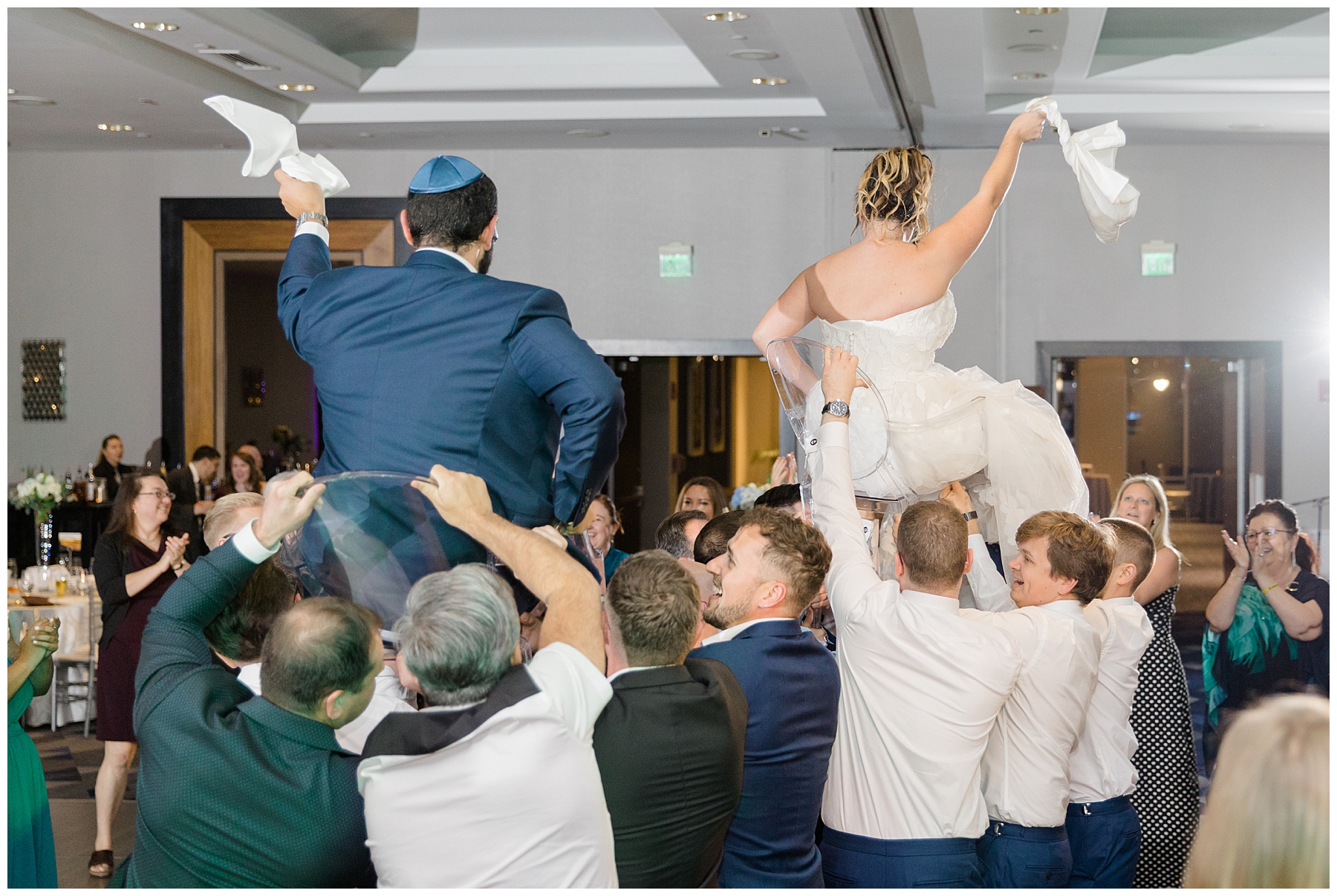 couple during traditional Jewish dance at wedding reception