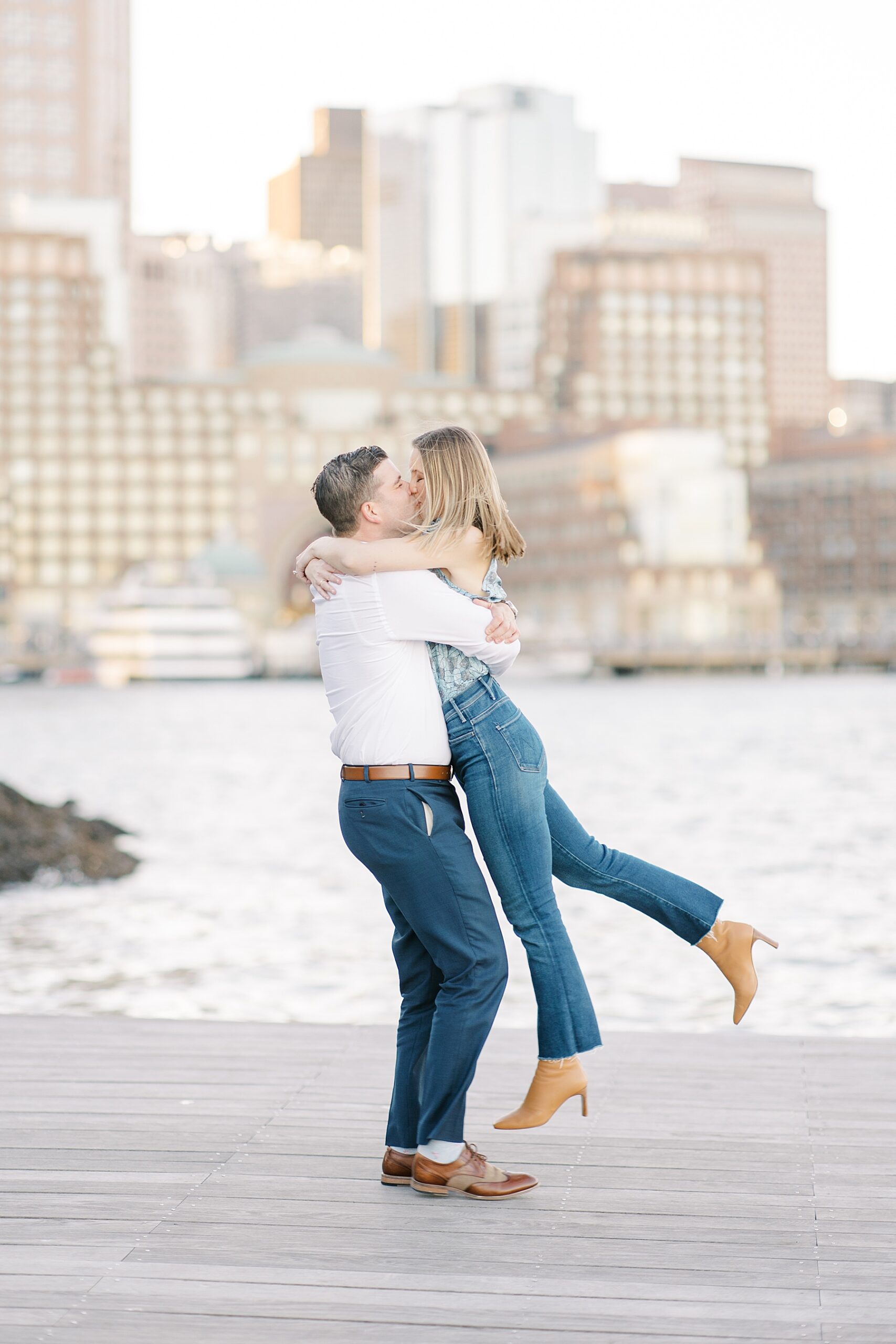Couple kiss at Fan Pier Park in Boston