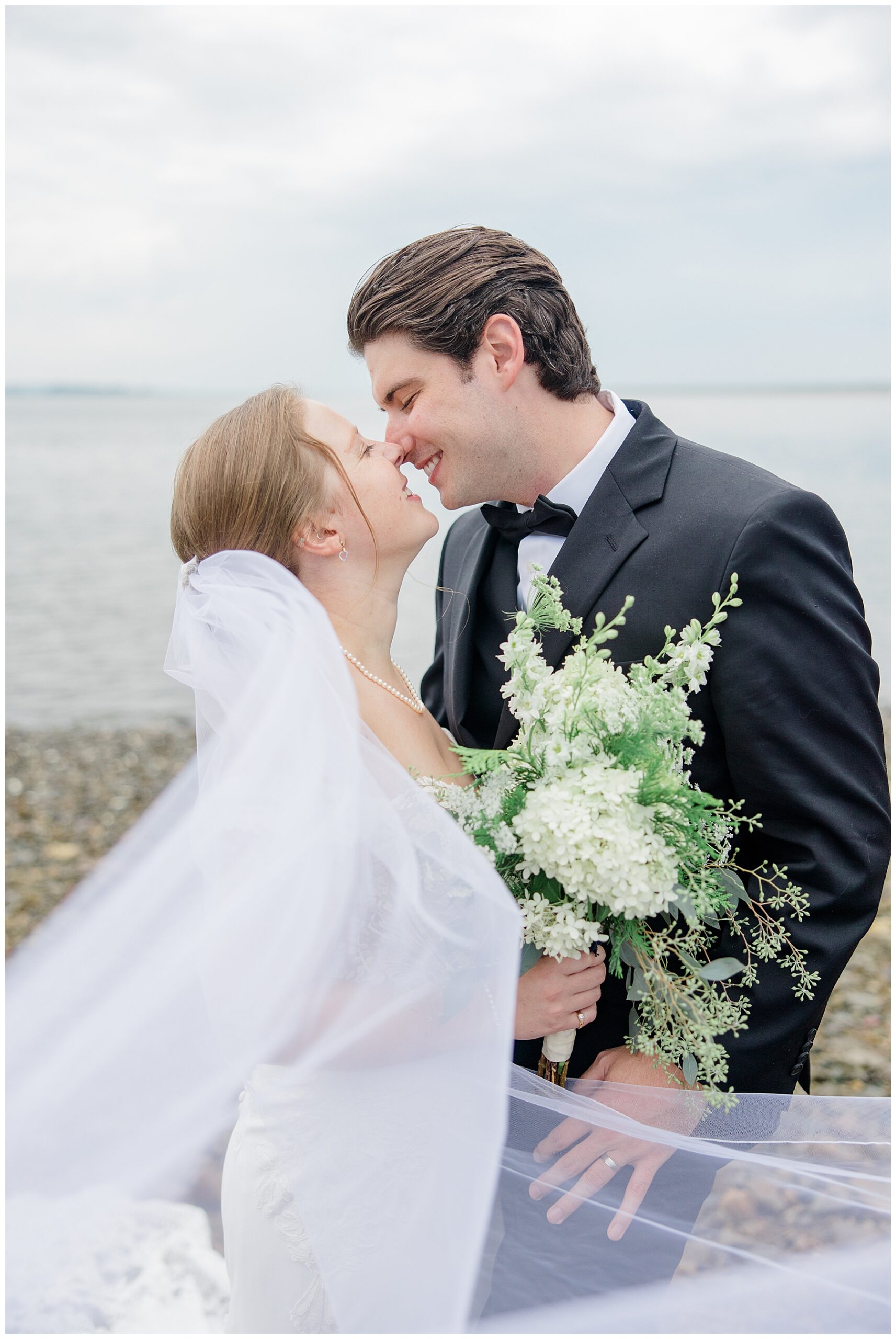 newlyweds lean in together during portraits 