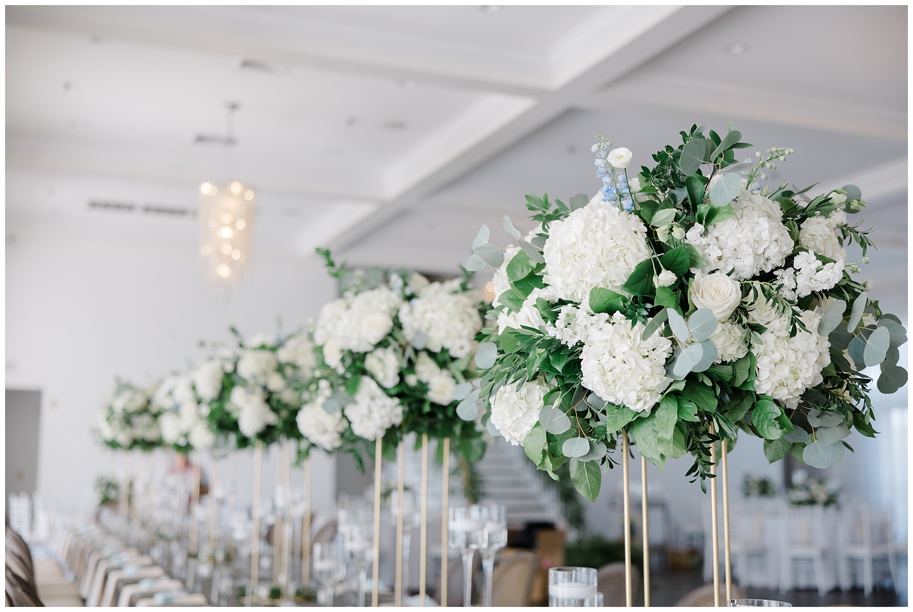 tall white rose centerpieces from wedding reception