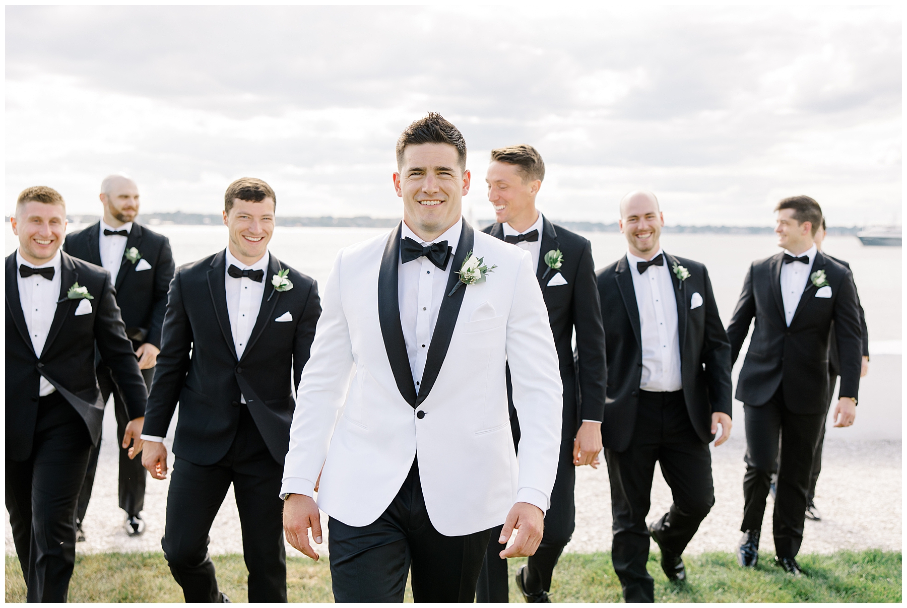 groom in white tux with groomsmen