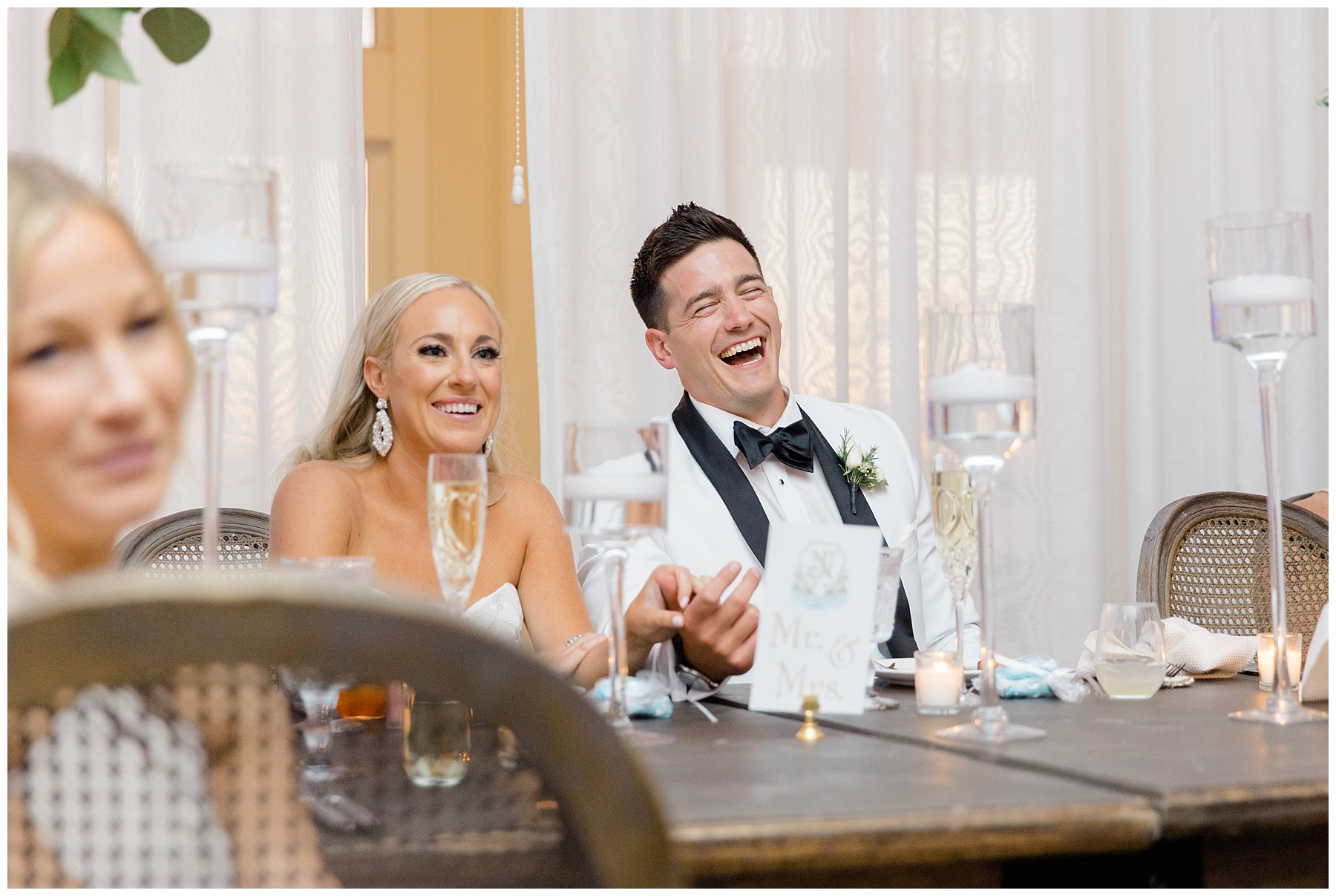 newlyweds listen to wedding toasts