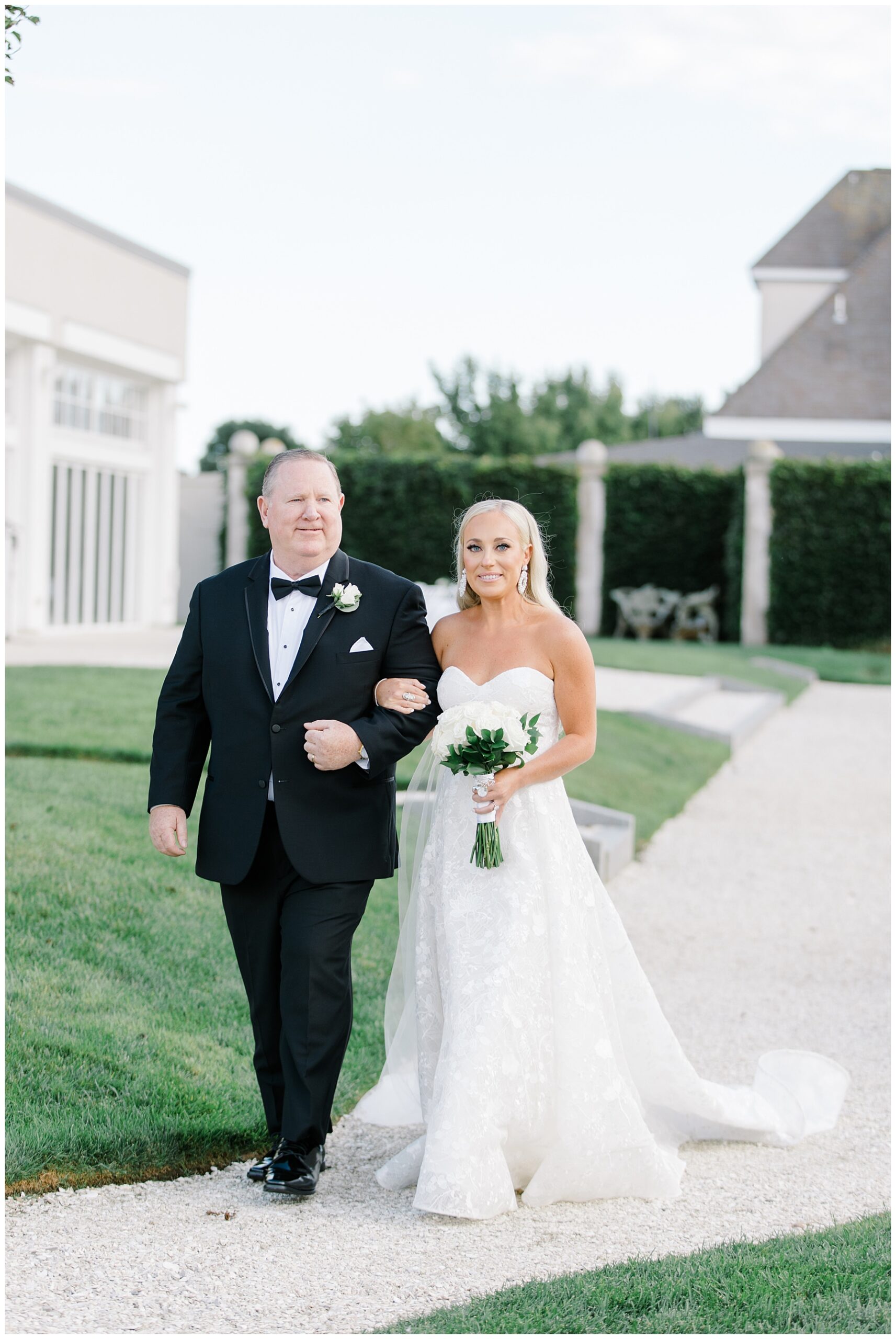 father of the bride walks daughter down the aisle