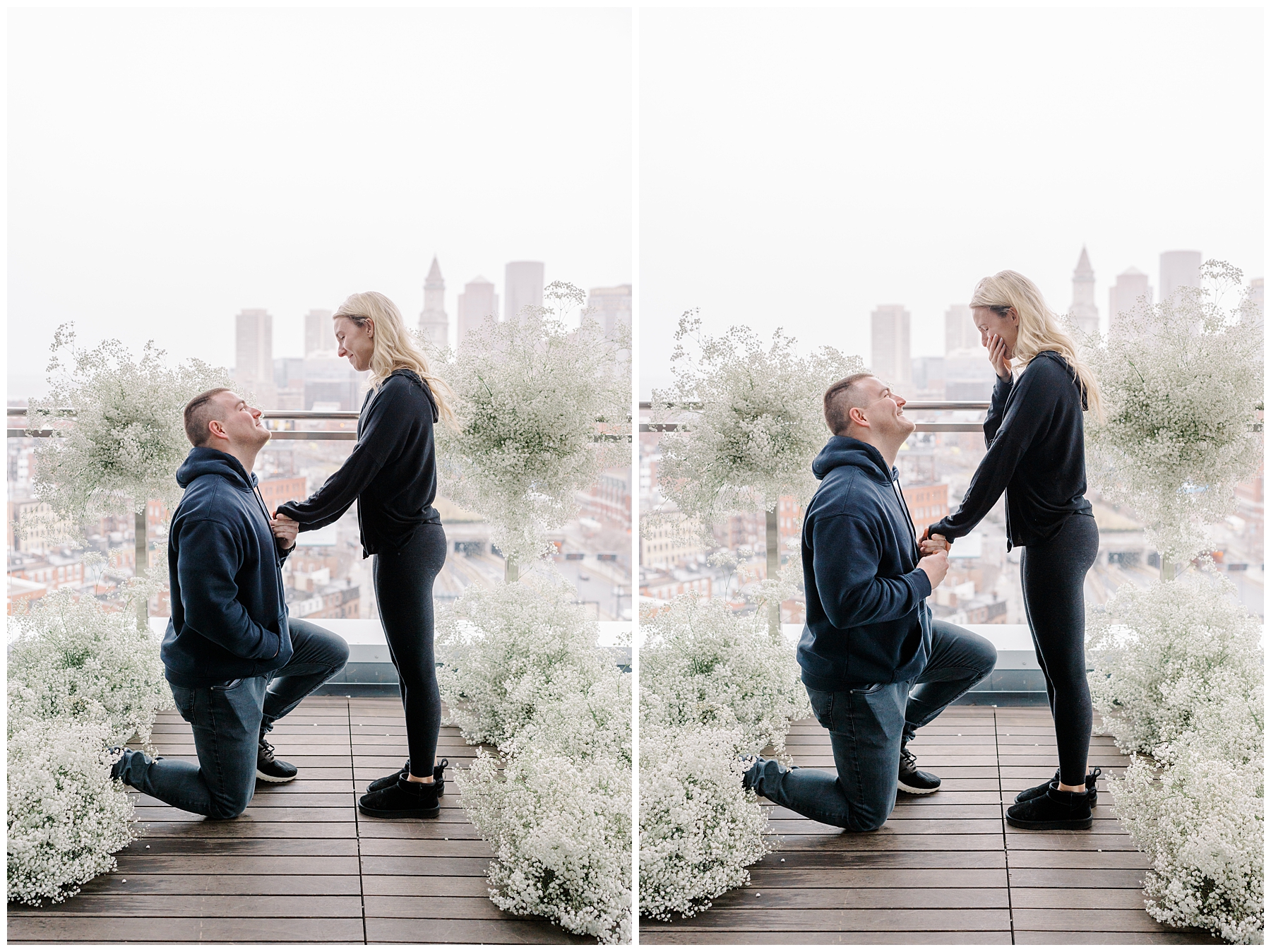 man proposes to girlfriend surrounded by white flowers on balcony with boston skyline in background