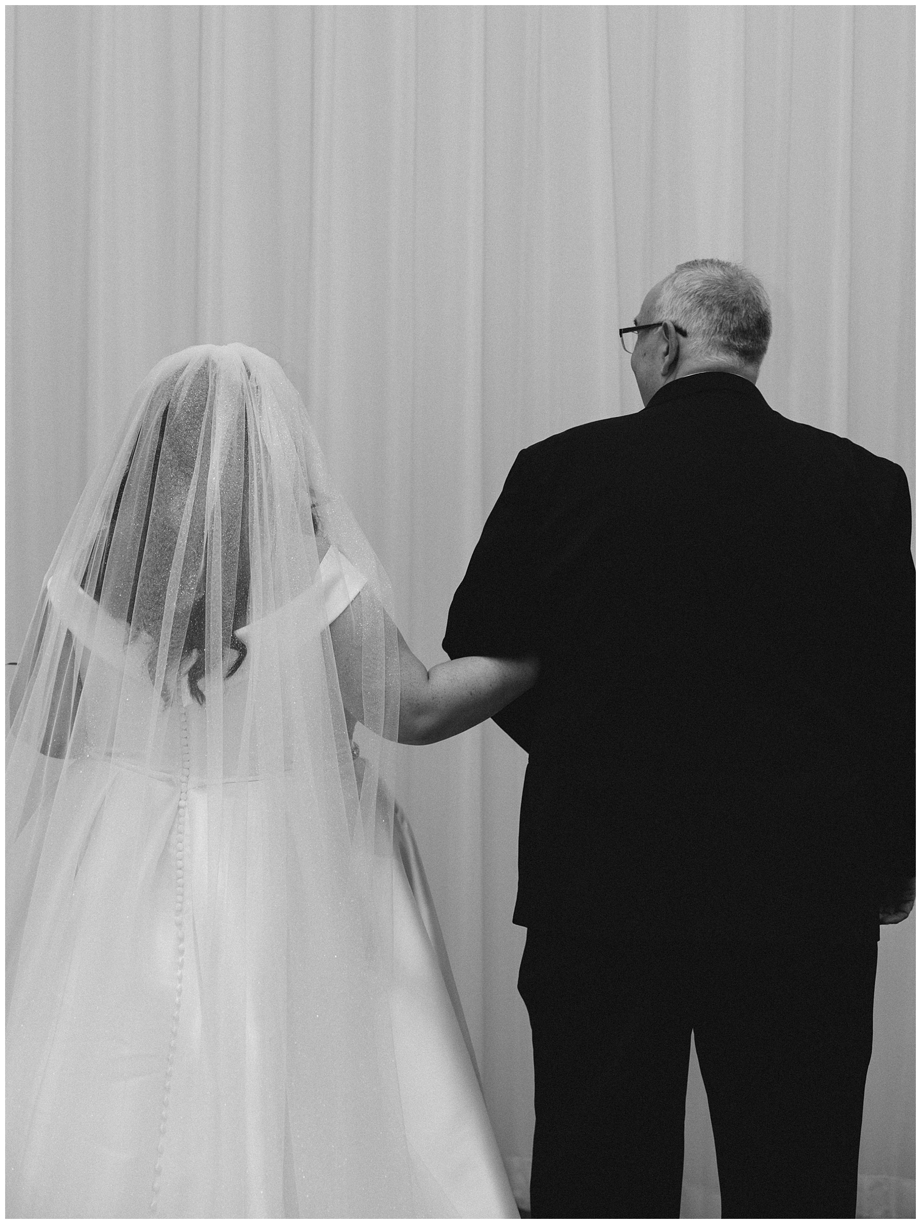 bride walks down aisle with father 
