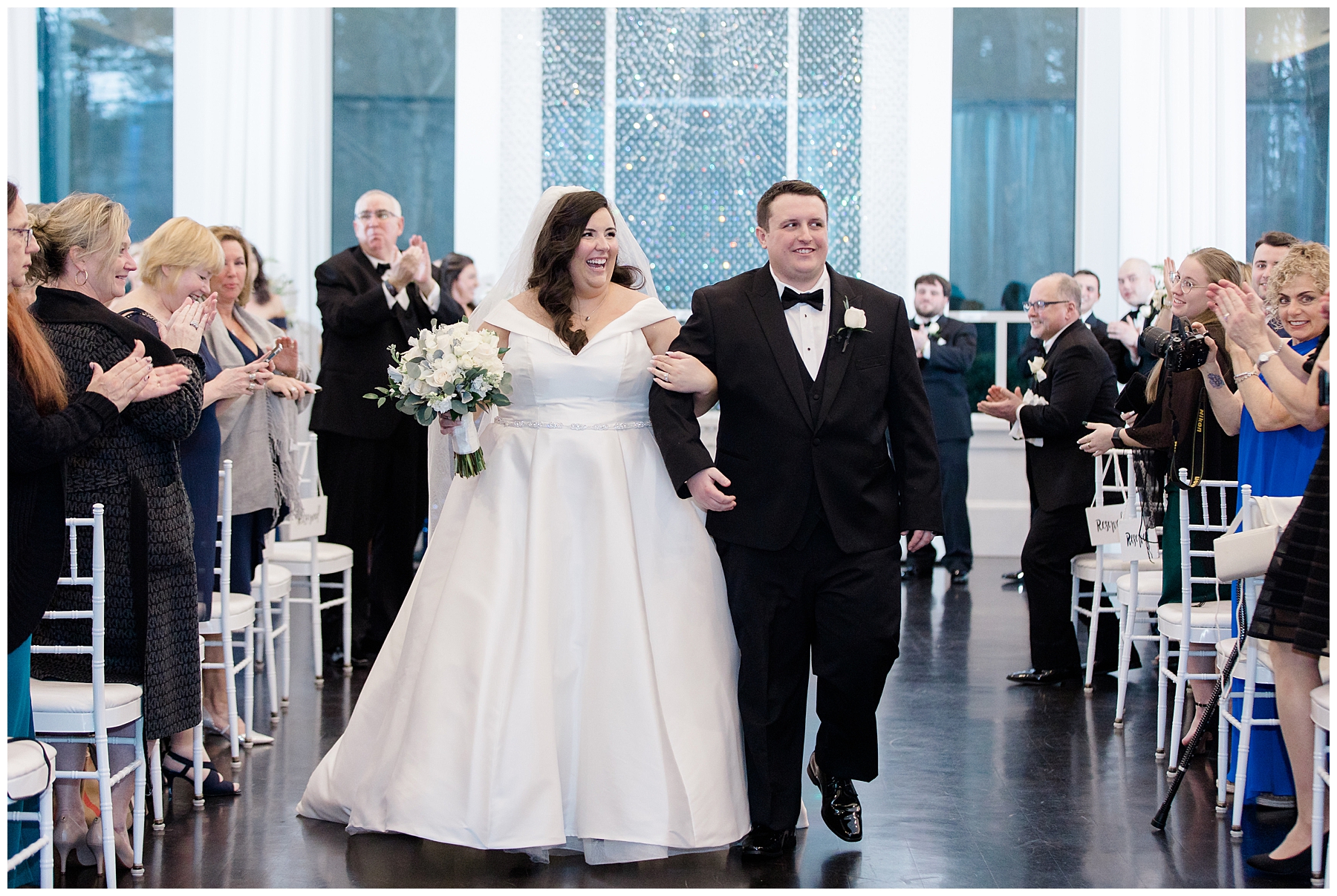 newlyweds exit church at Elegant Lakeview Pavilion Wedding 