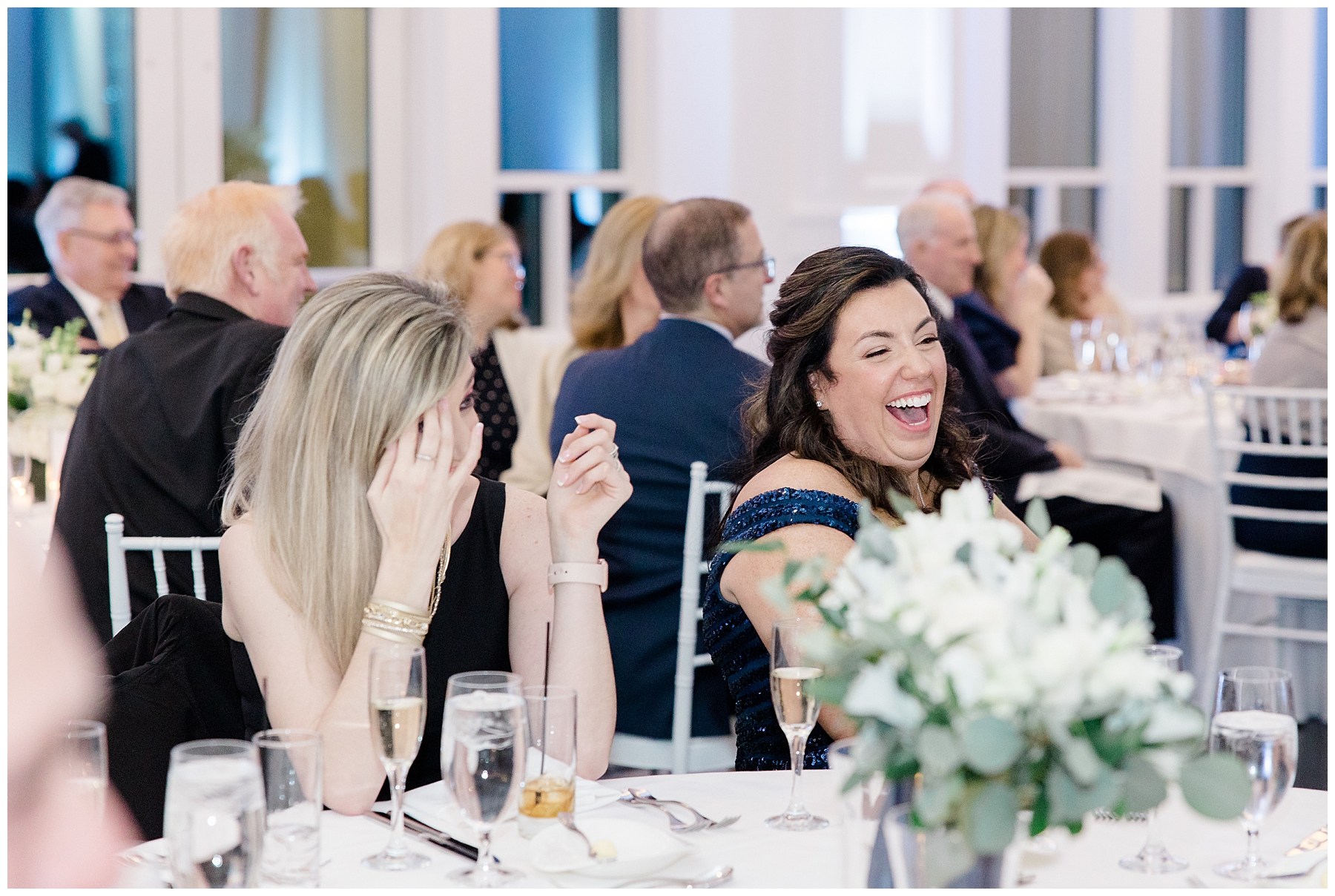 guests laugh during wedding speeches