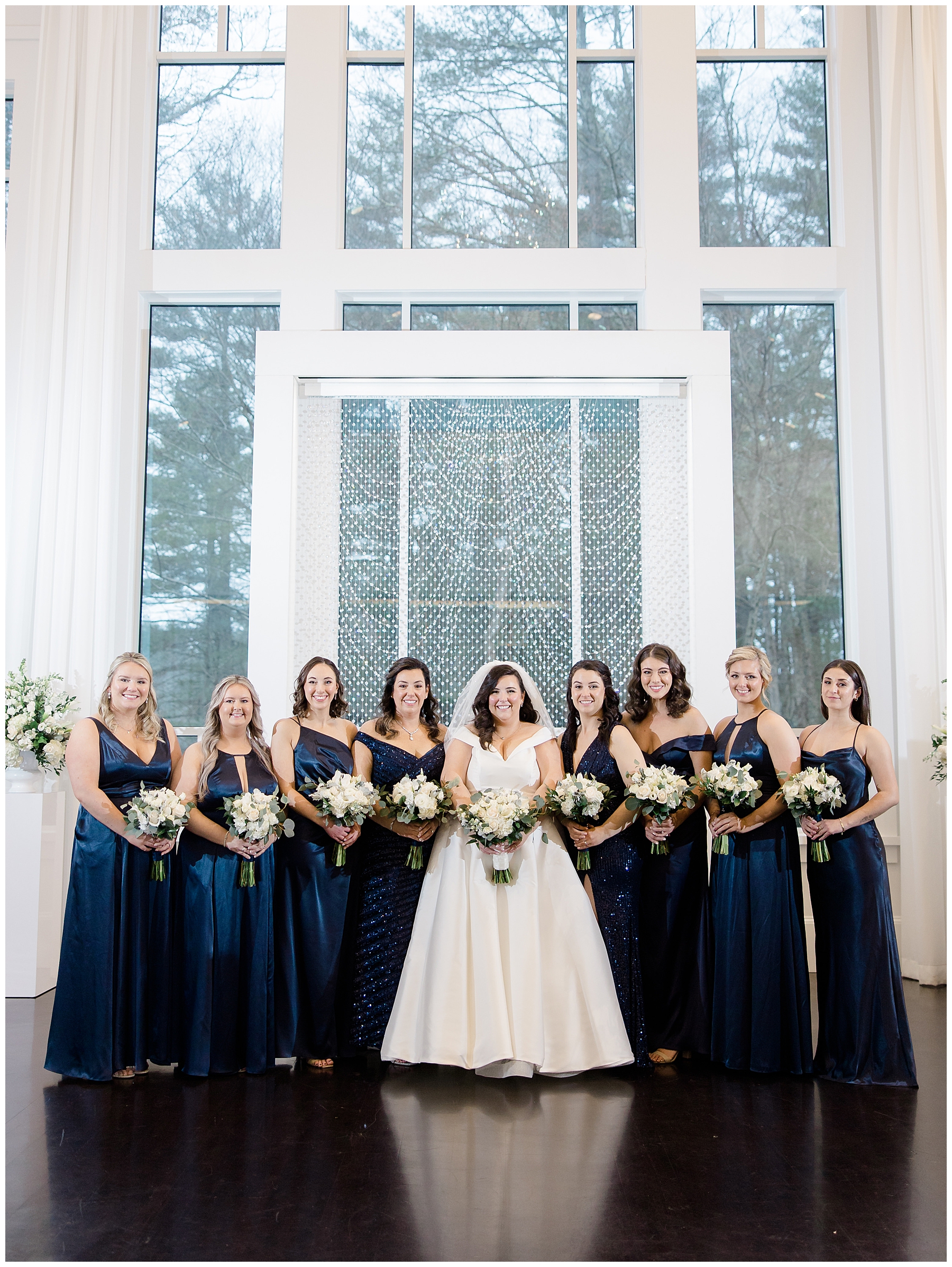 bride and bridesmaids in navy dresses 