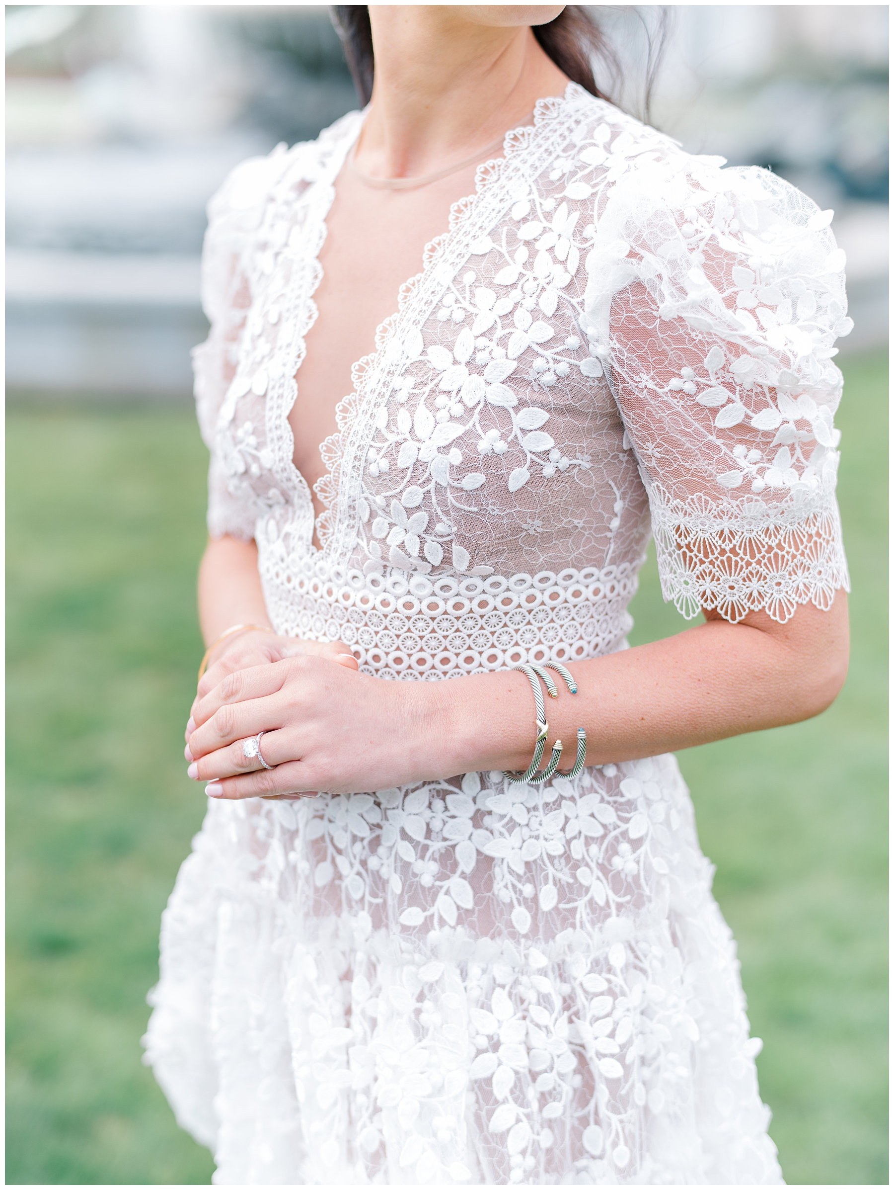 bride to be shows off white lace dress and engagement ring
