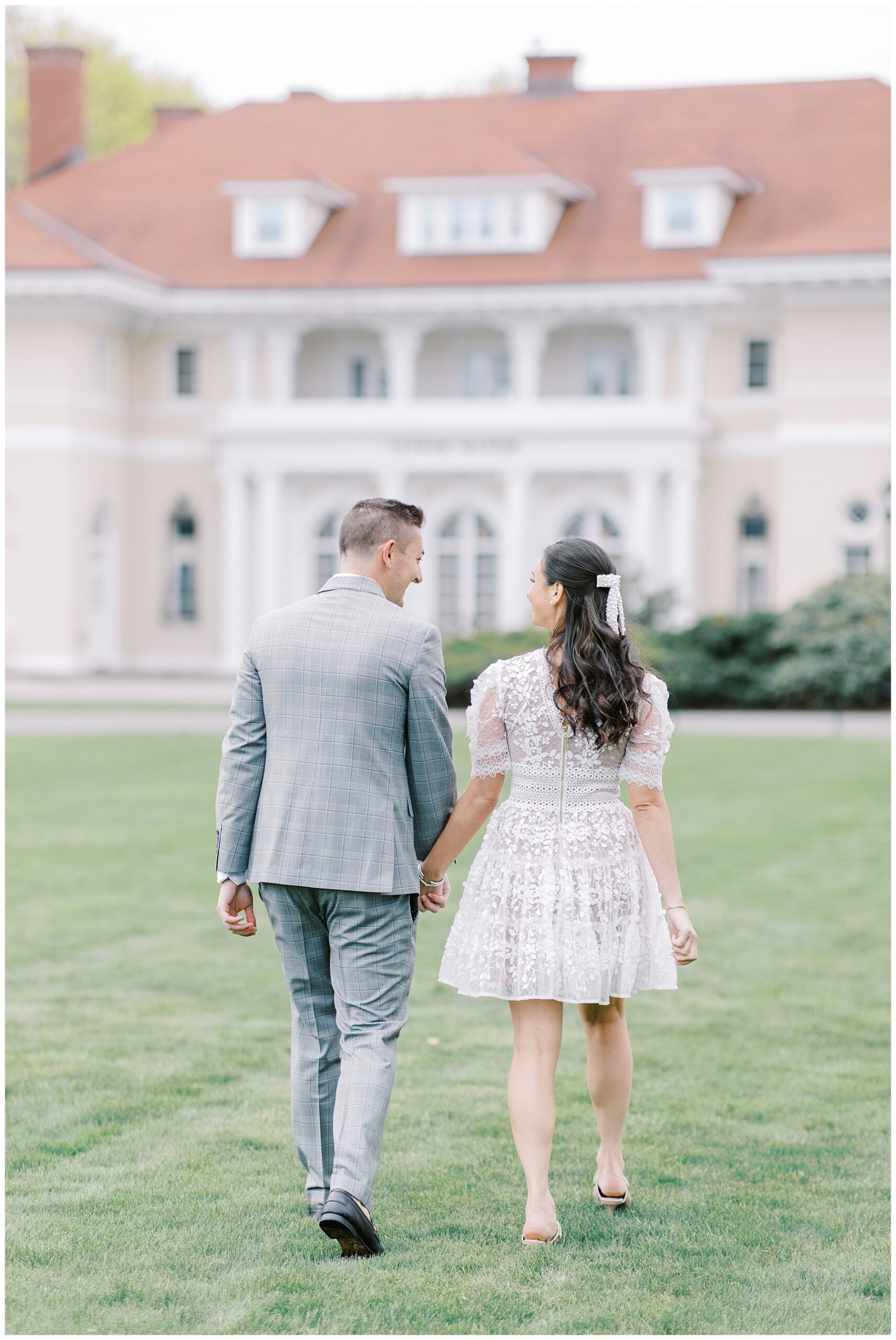 couple walking towards estate of Tupper Manor for Bridal Shower