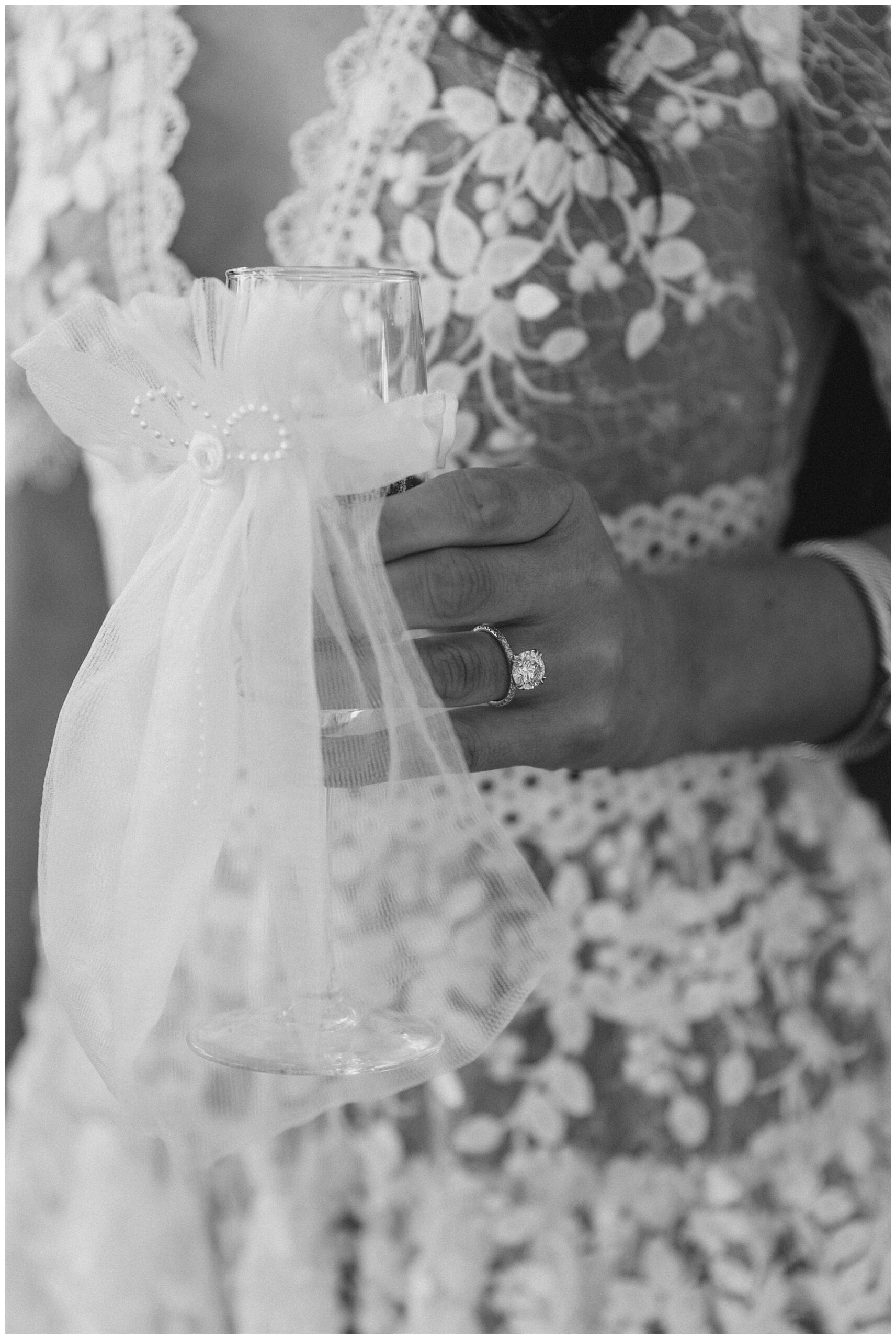 bride holding glass with veil on it