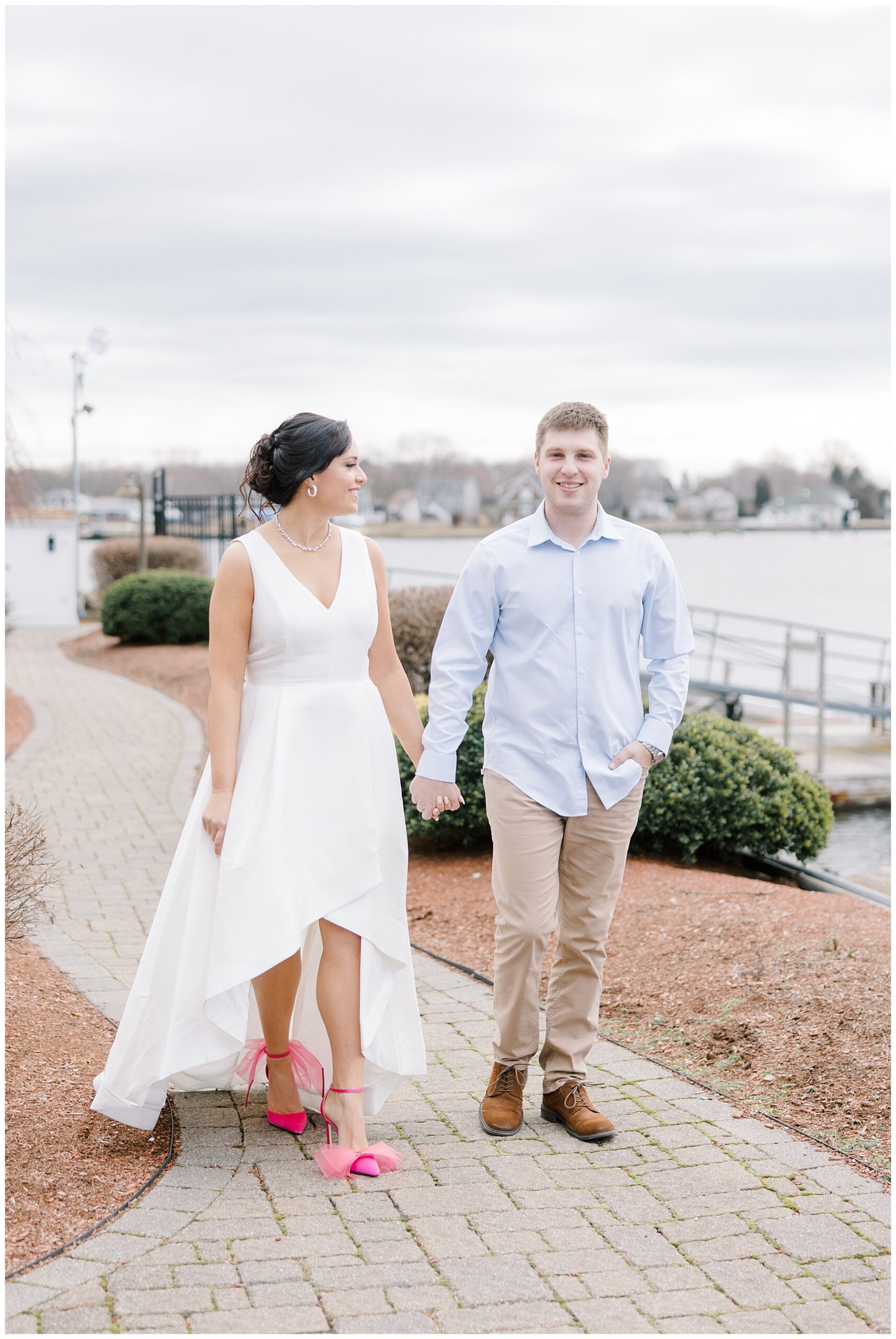 engaged couple walk together near coastal venue, Danversport 