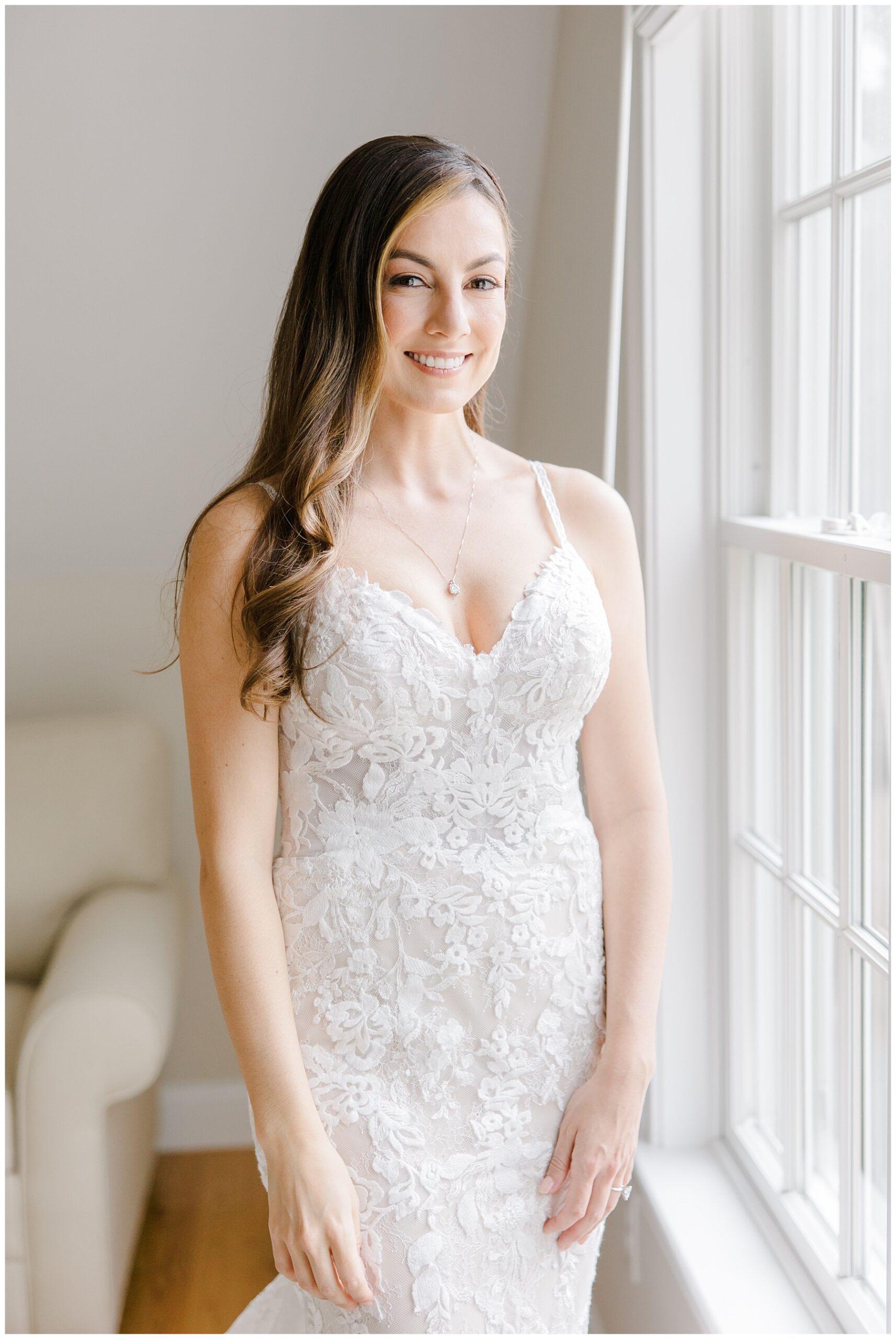 elegant bride standing by window 