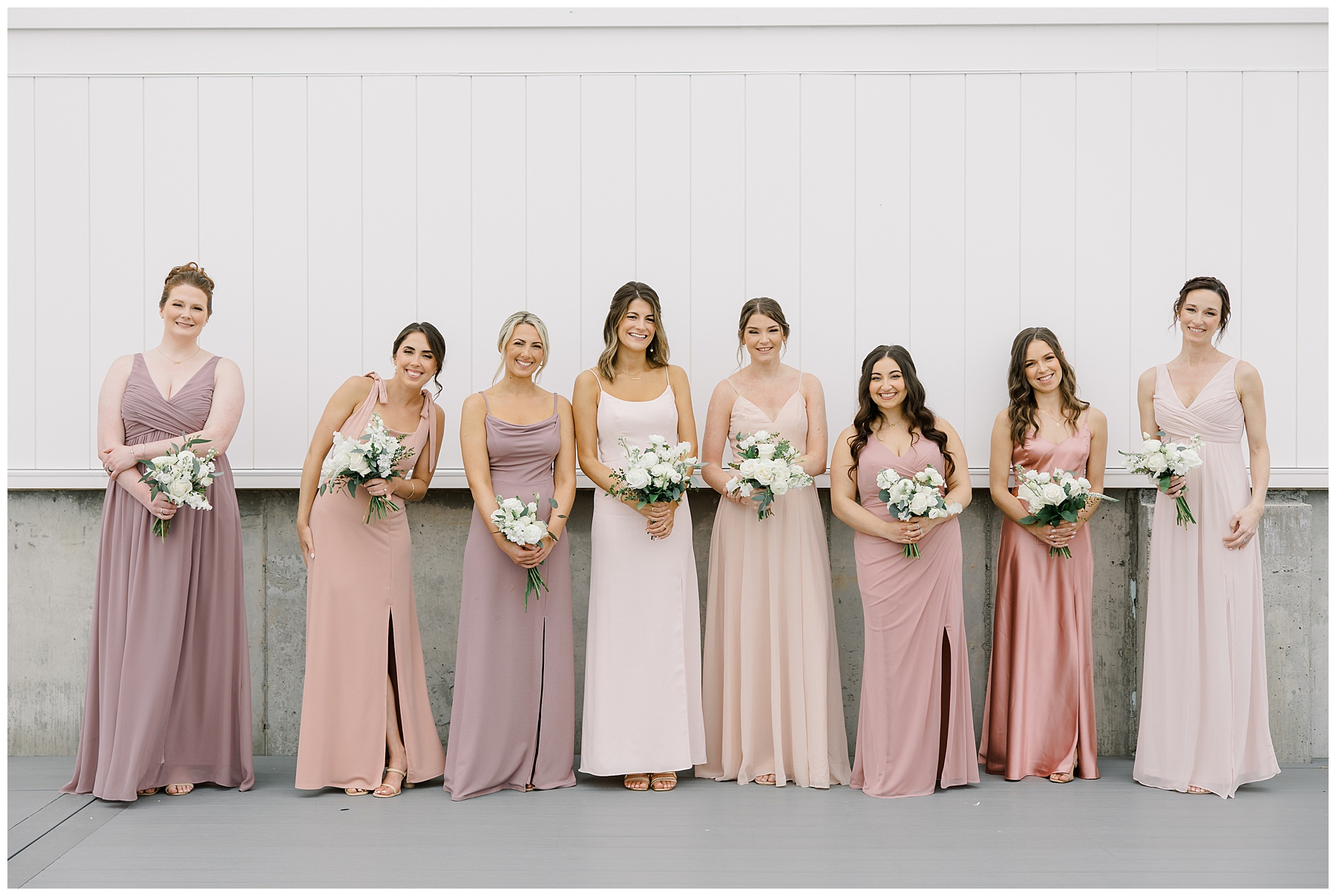 bride with bridesmaids in different styles of blush pink dresses