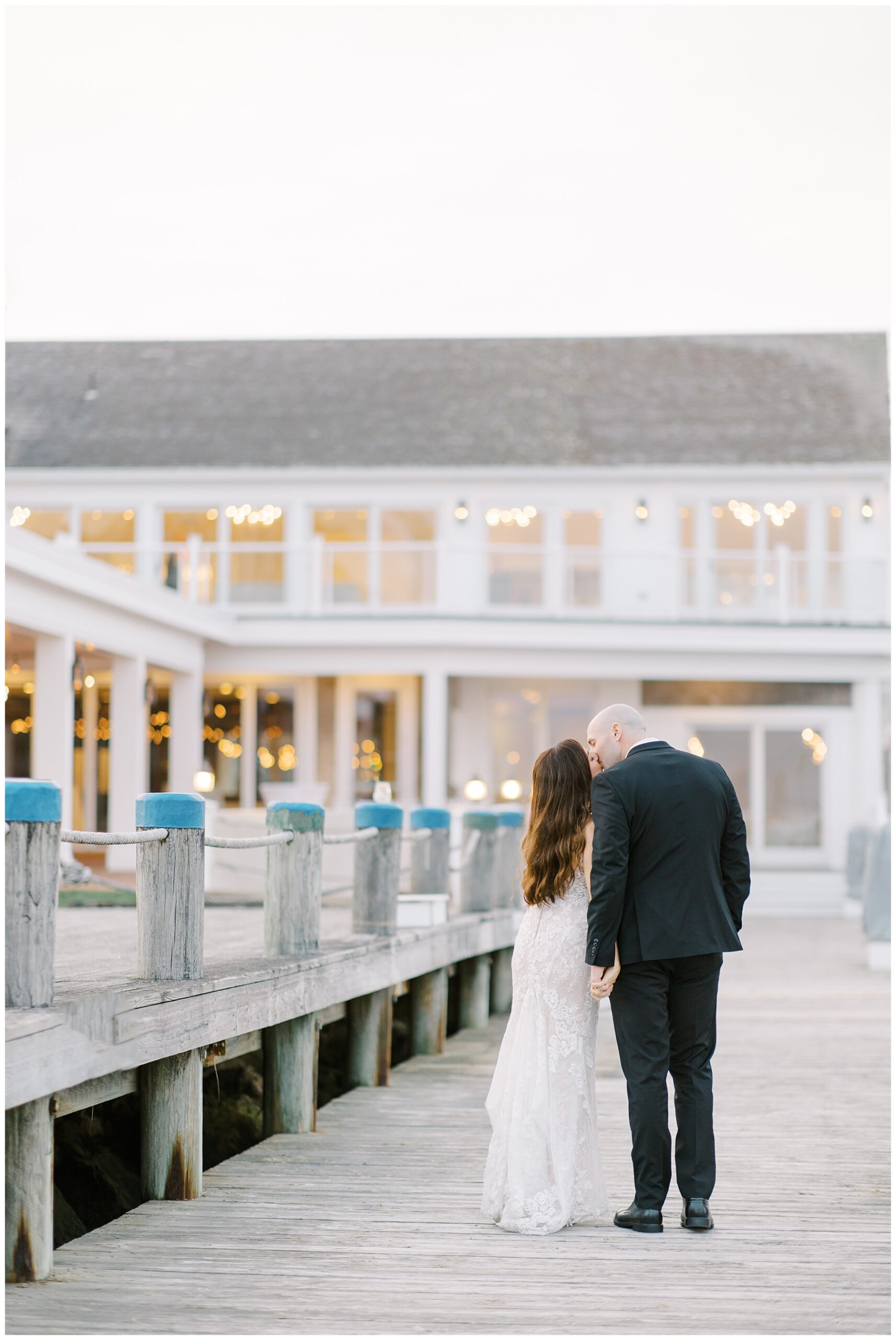 Couple stand outside on the docks of Wychmere Beach Club Wedding