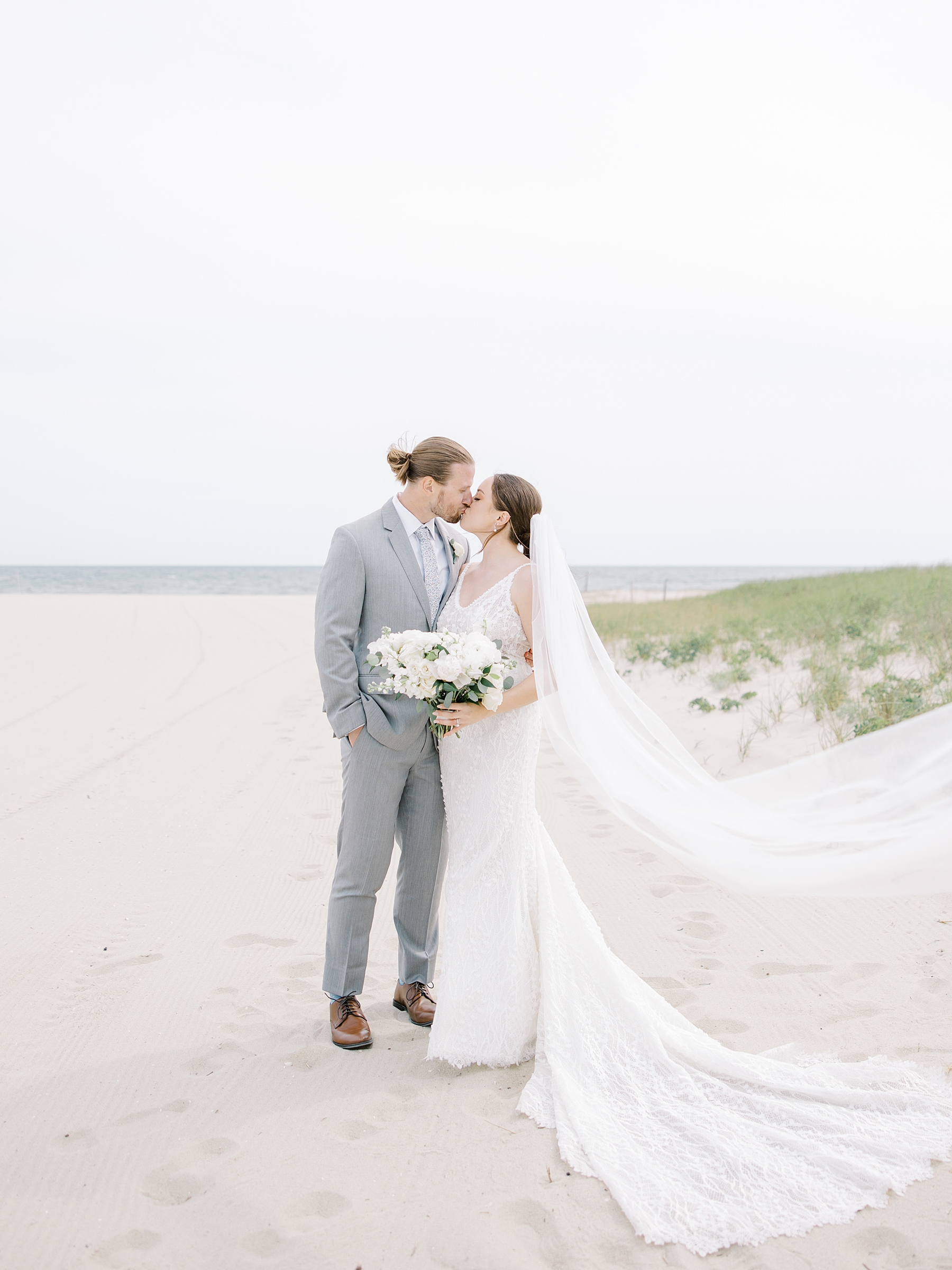 newlyweds kiss on Cape Cod beach