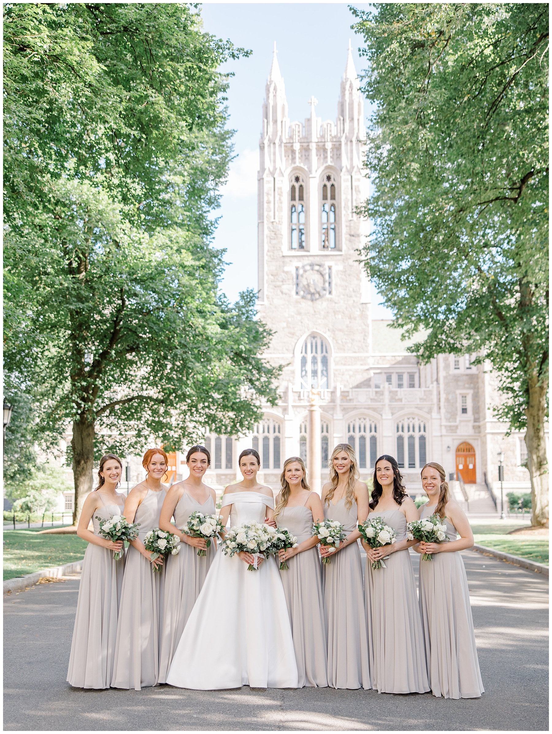bride and bridesmaids in taupe dresses outside of grand Boston church