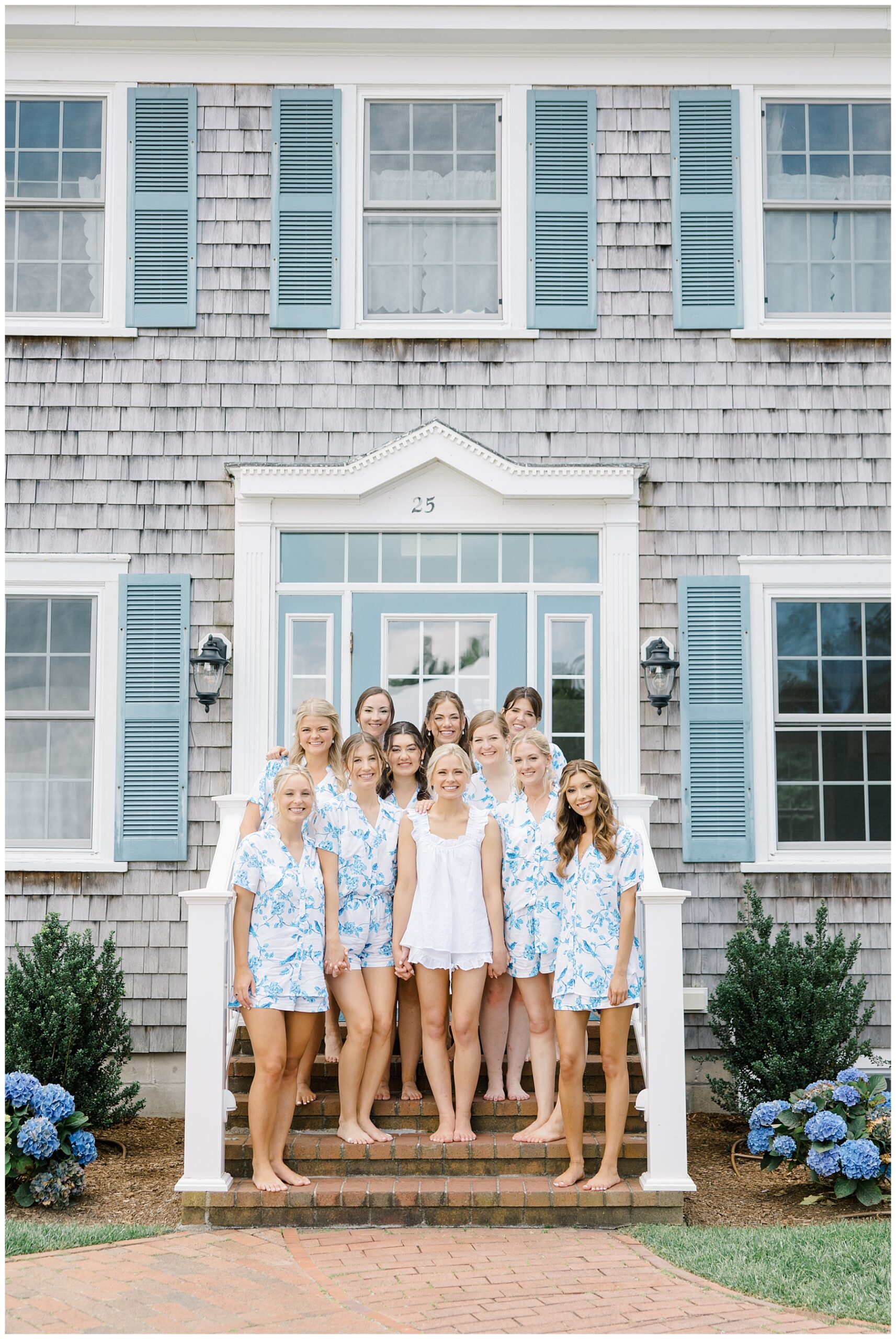 Bride and bridesmaids in matching pjs on steps of The Dennis Inn