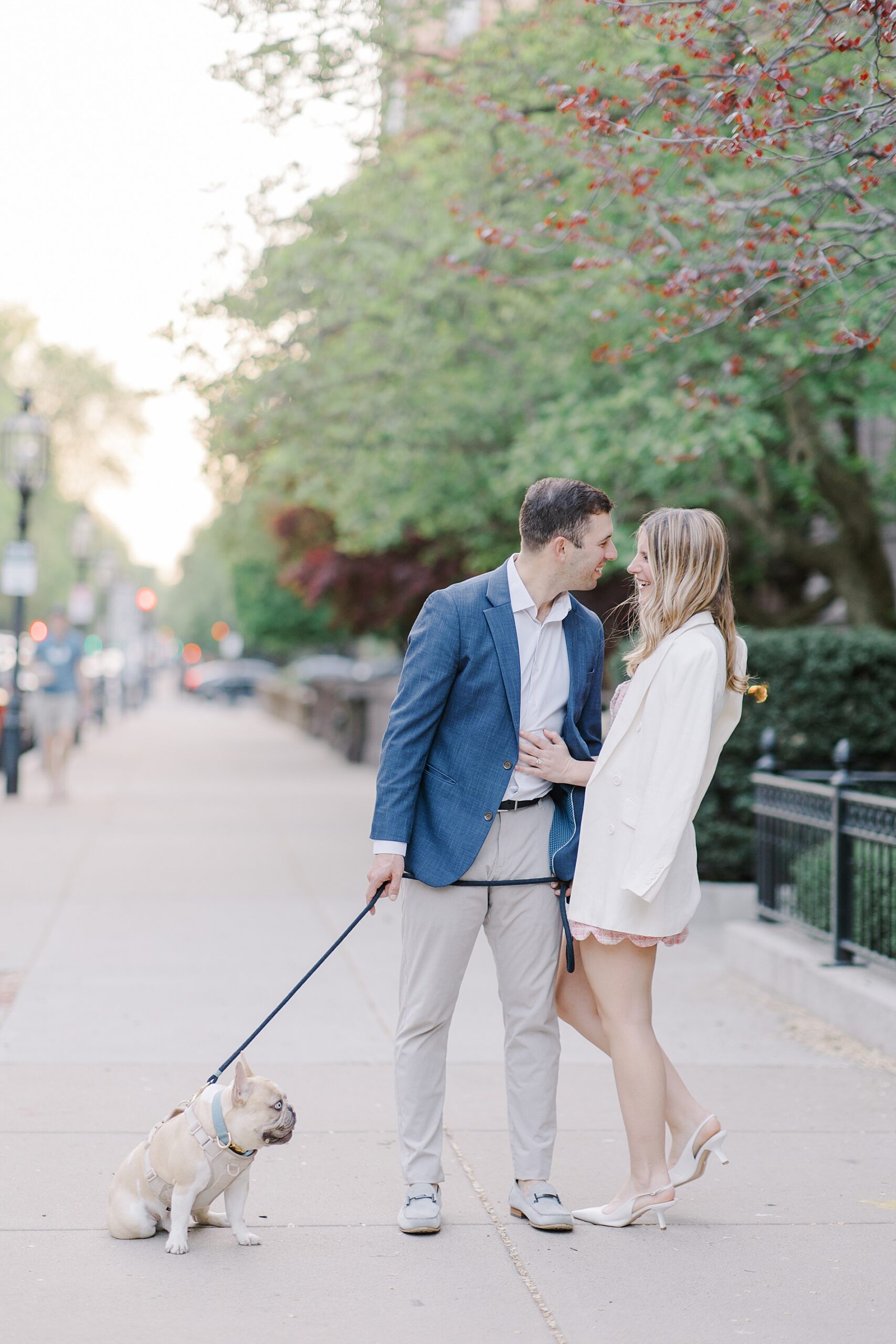 couple walk their dog in Boston during engagement session