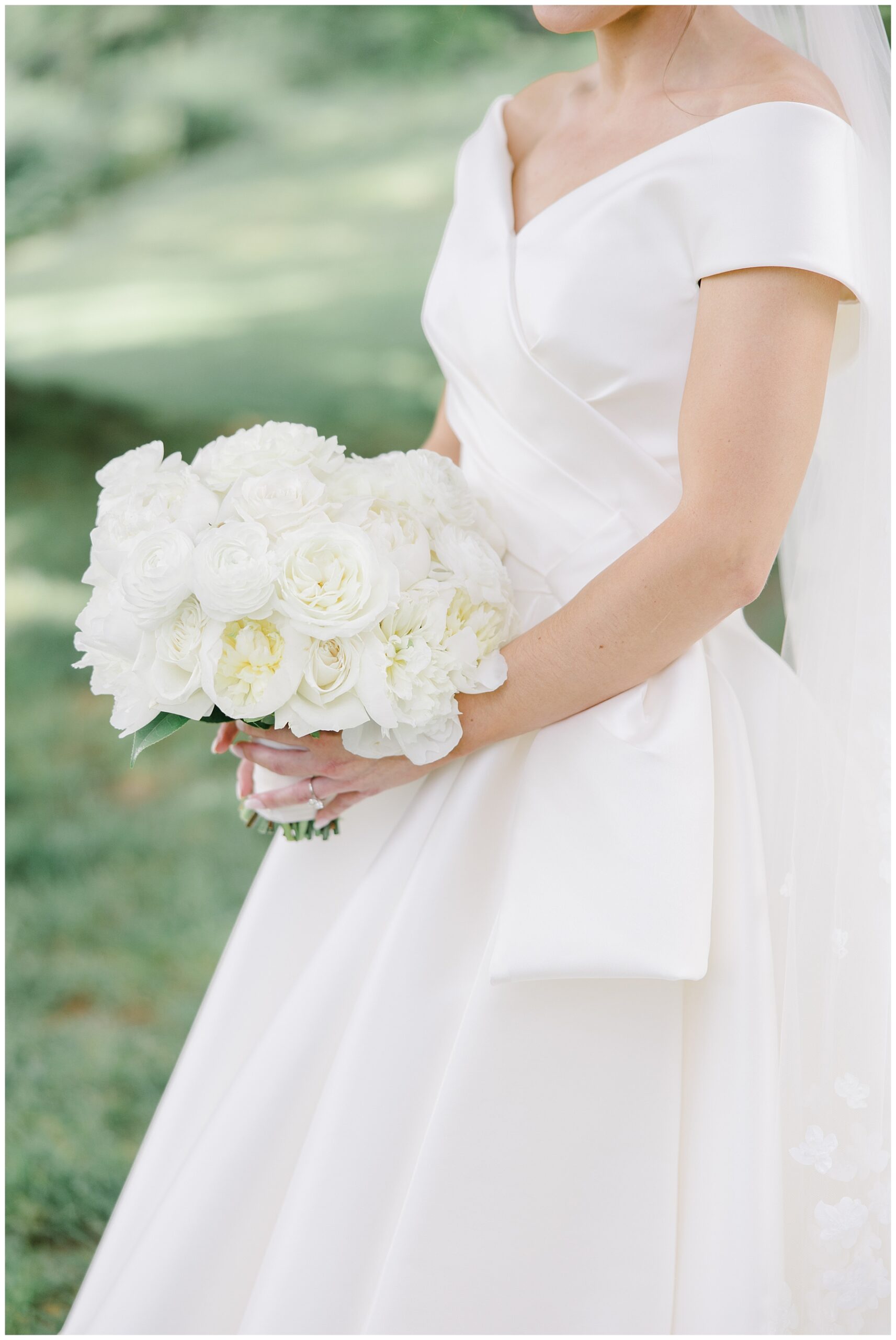 elegant wedding gown and classic white rose wedding bouquet 