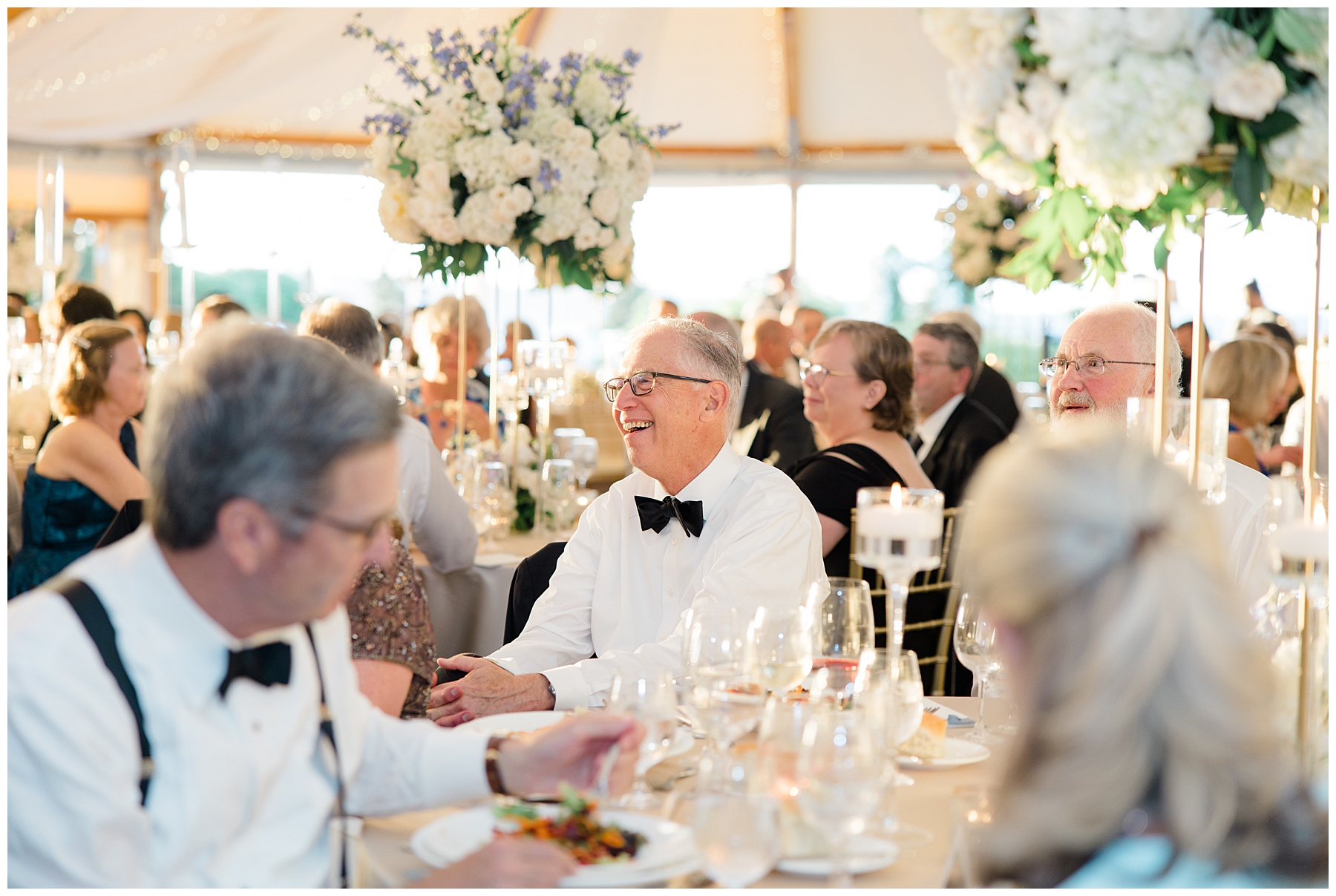 wedding guests laugh during toasts 