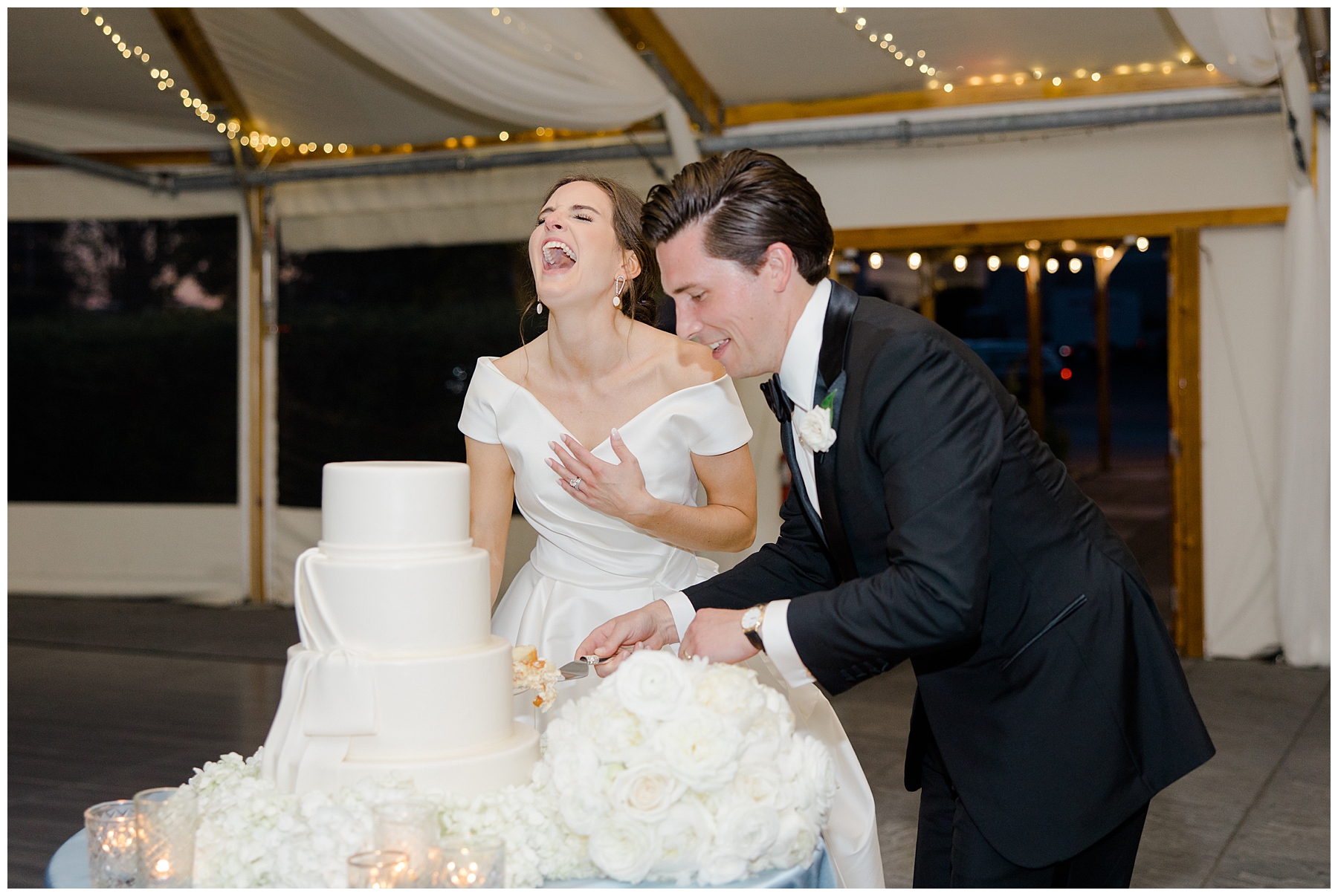 candid moment as couple cut their wedding cake