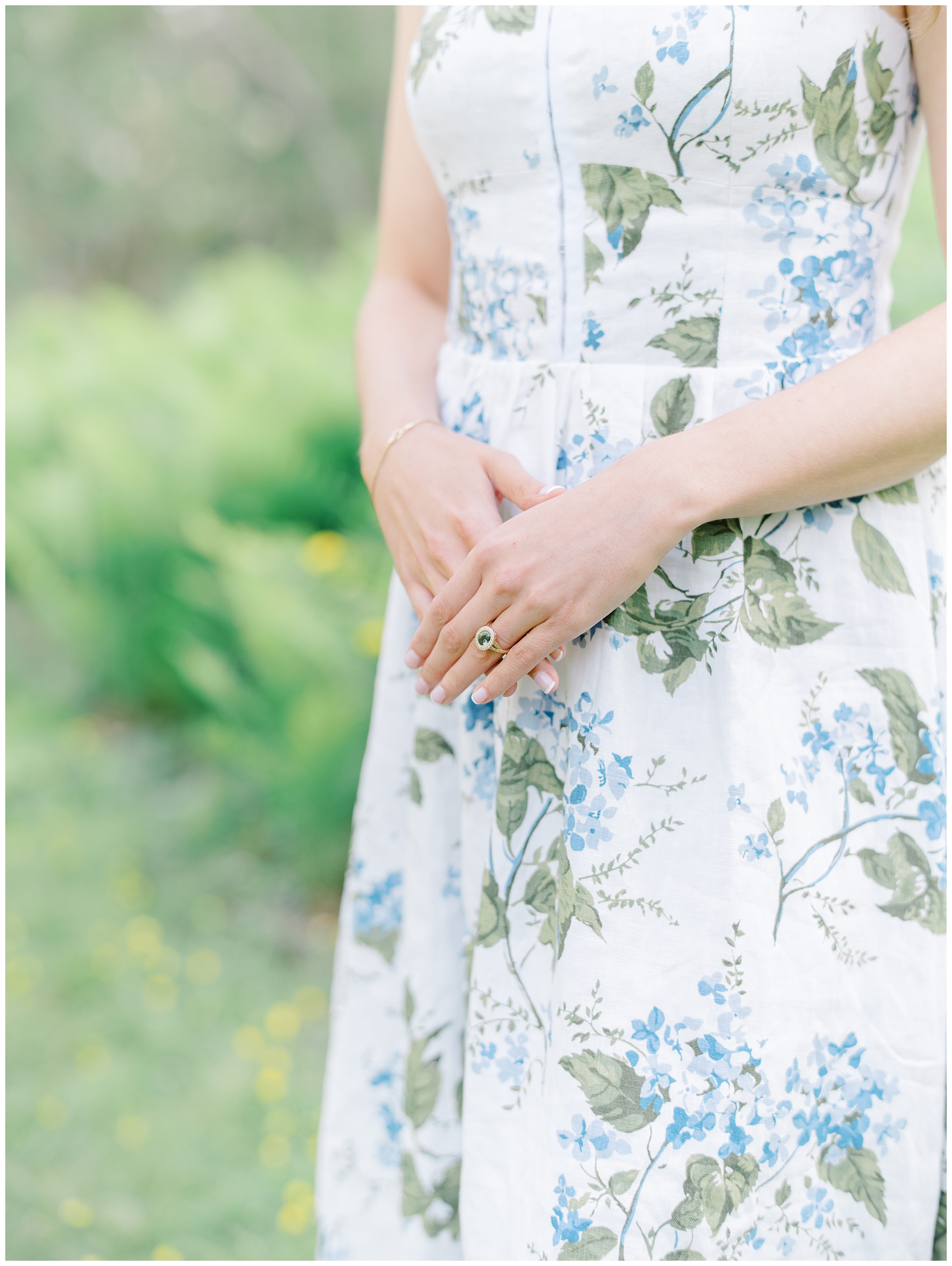 girl in floral dress and engagement ring