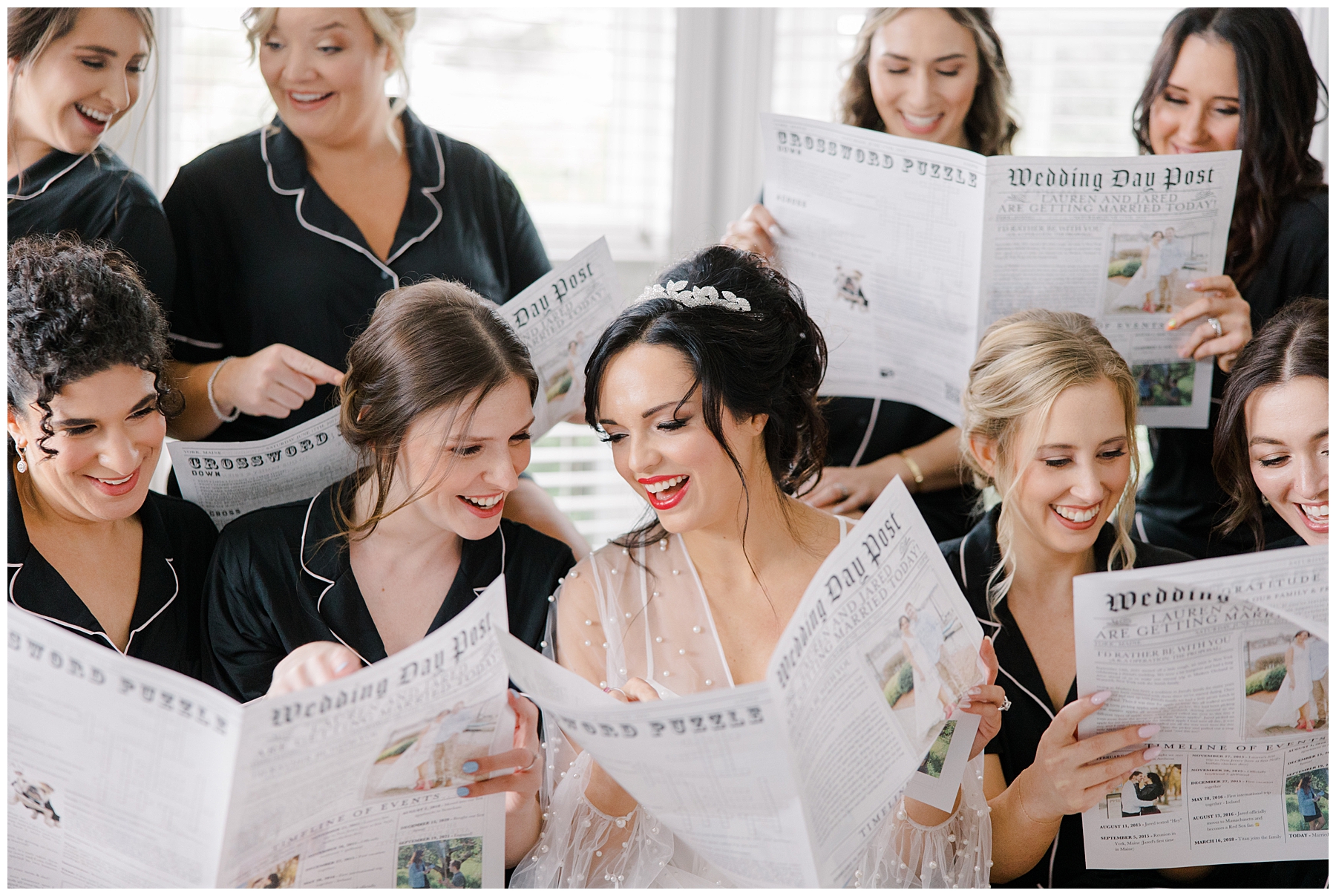 bride and bridesmaids looking at custom newspaper 