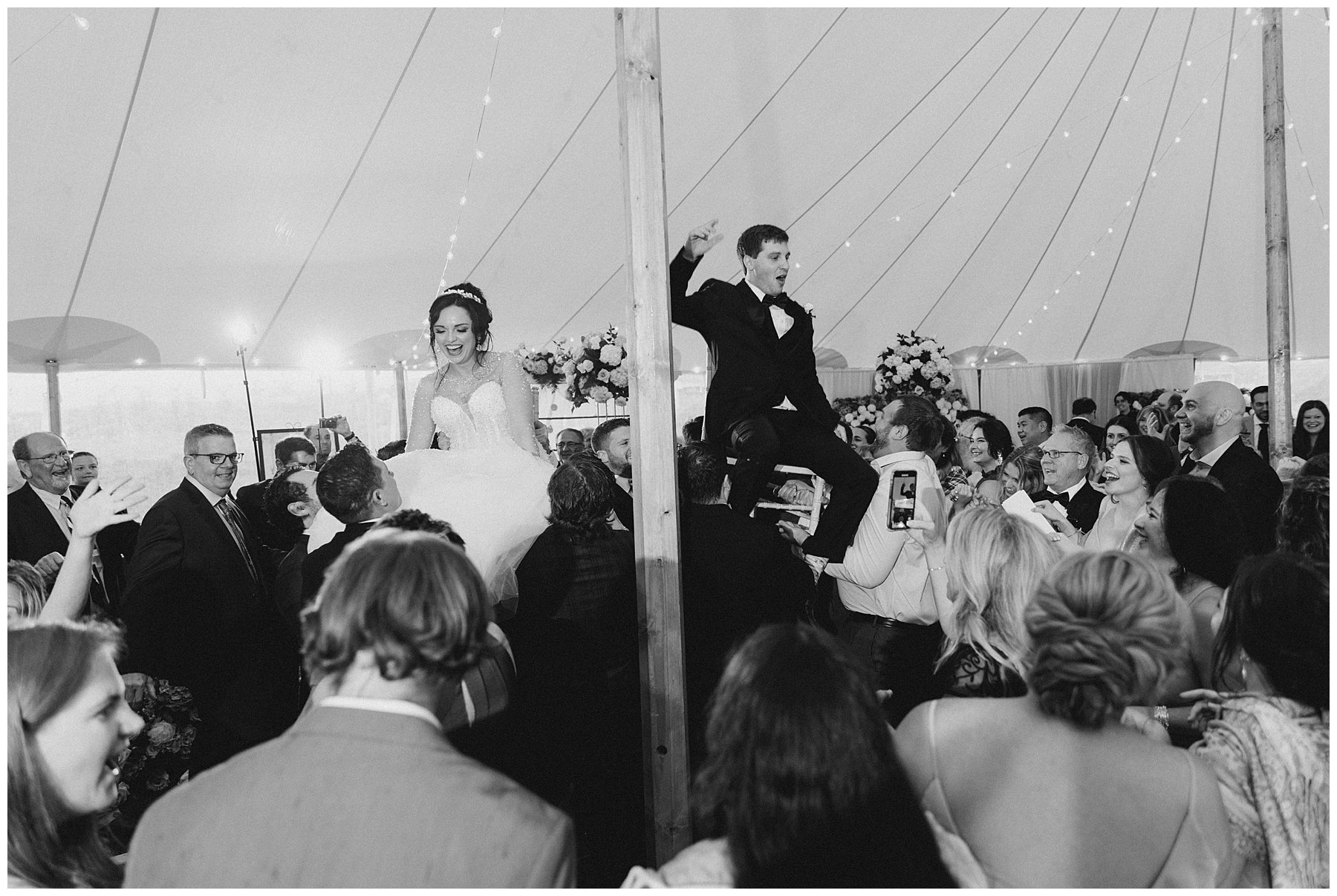 wedding guests lift bride and groom 