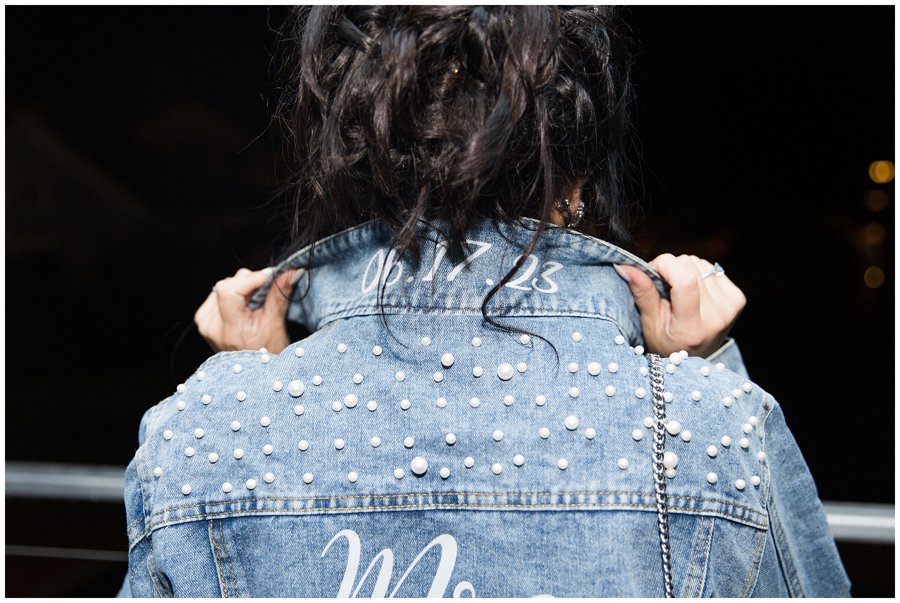 bride wearing custom jean jacket with last name and wedding date