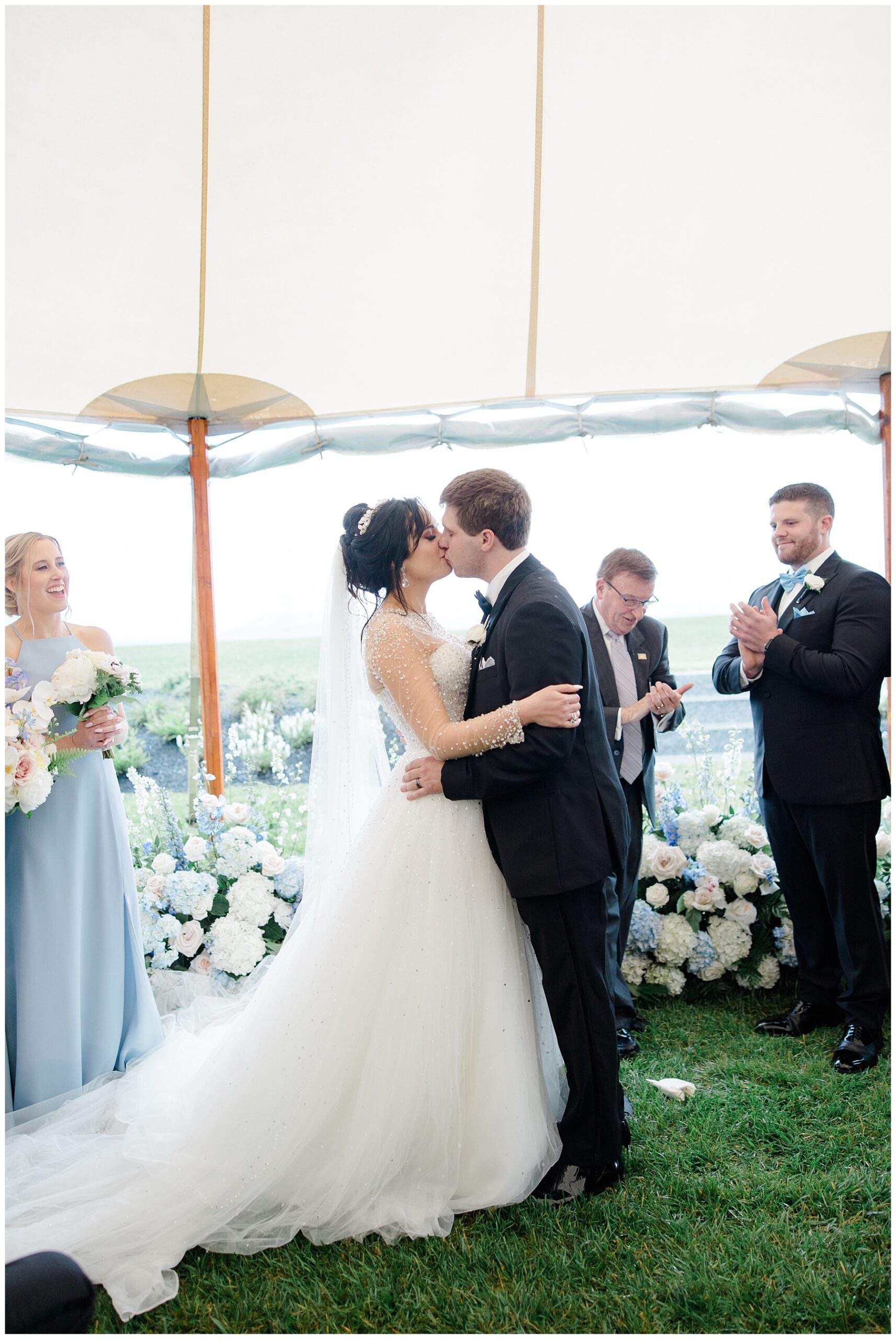 bride and groom kiss during Maine wedding ceremony